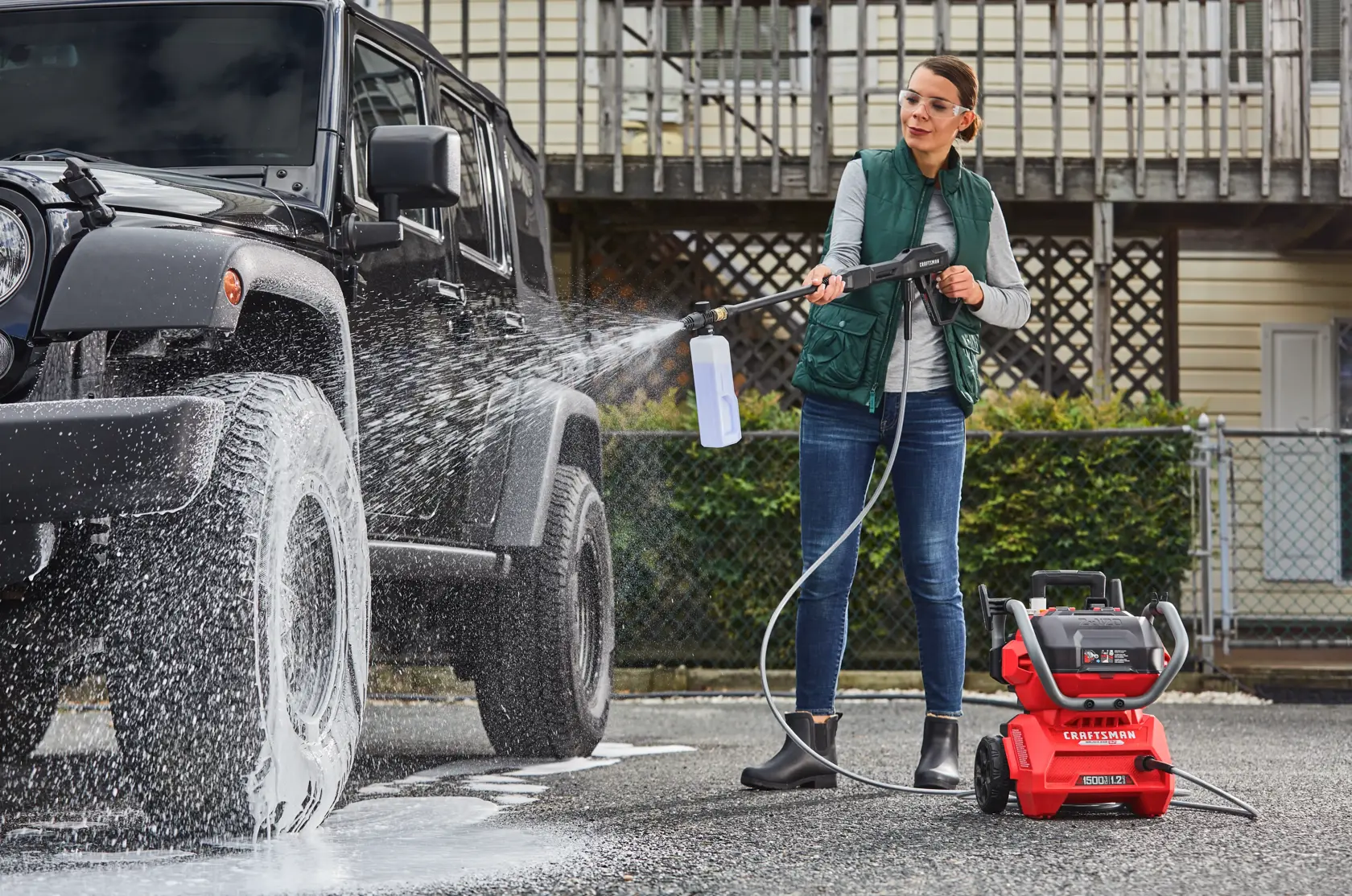 CRAFTSMAN 1500 PSI Pressure Washer pressure washing a vehicle in driveway with house in background