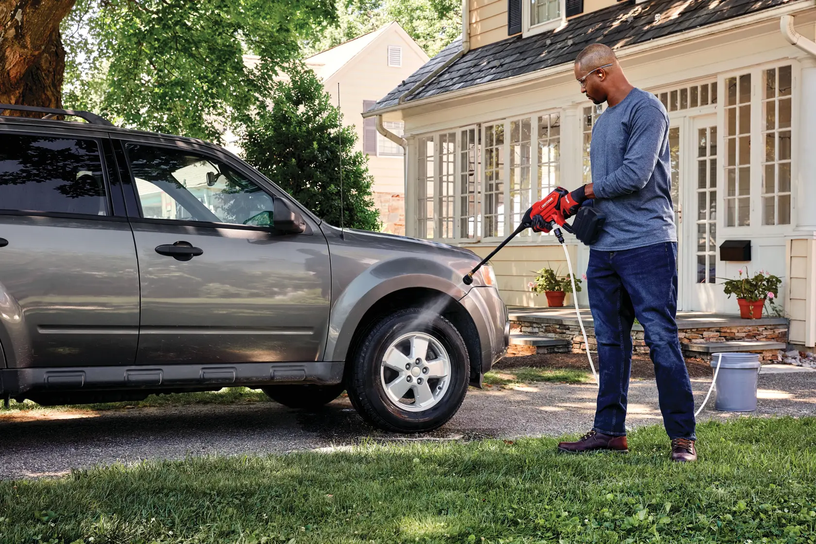 20 volt cordless 350 max P S I power cleaner kit being used by a person to clean car tyre.