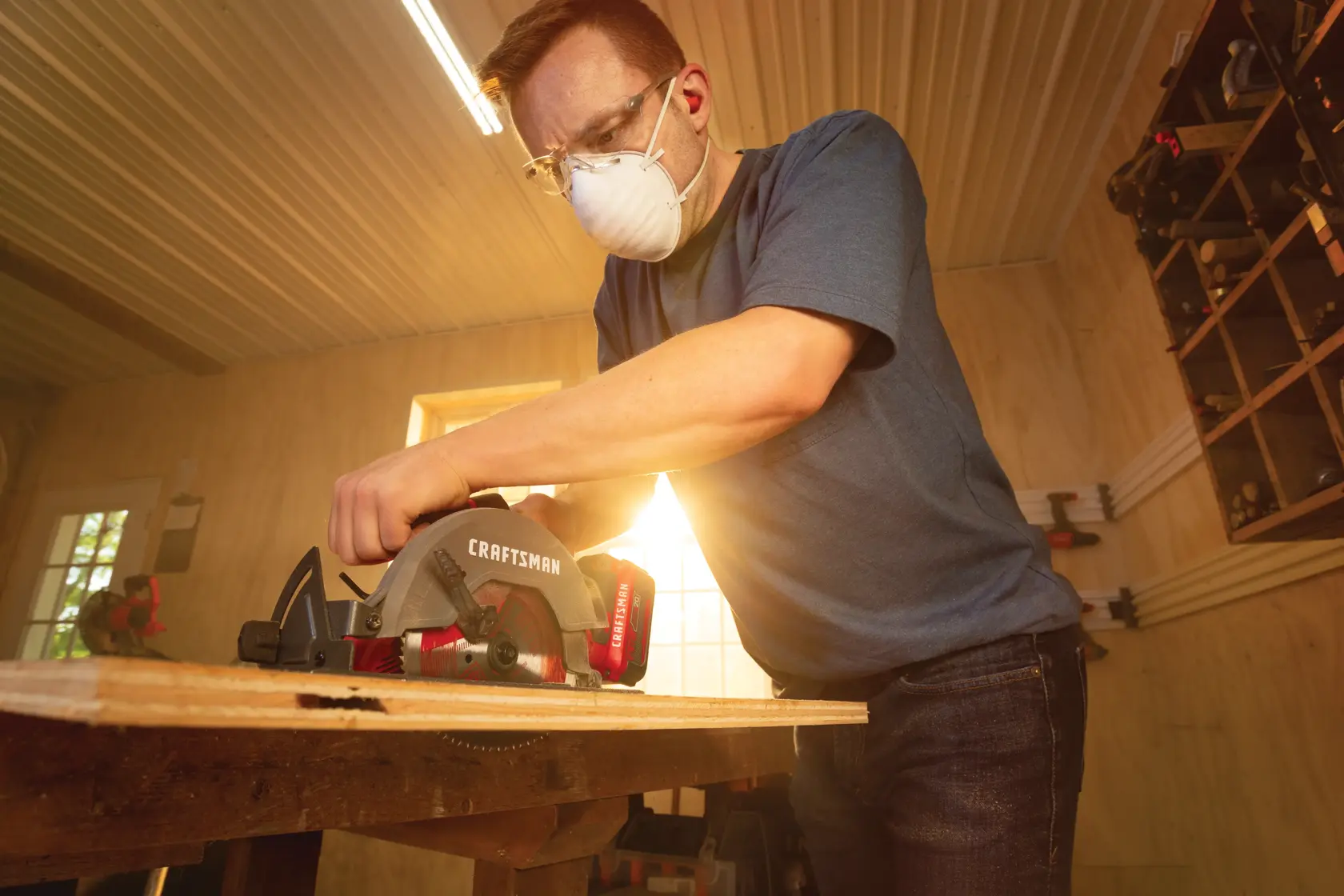 22 volt cordless 6 1 half inch circular saw kit being used by a person to cut wooden plank.