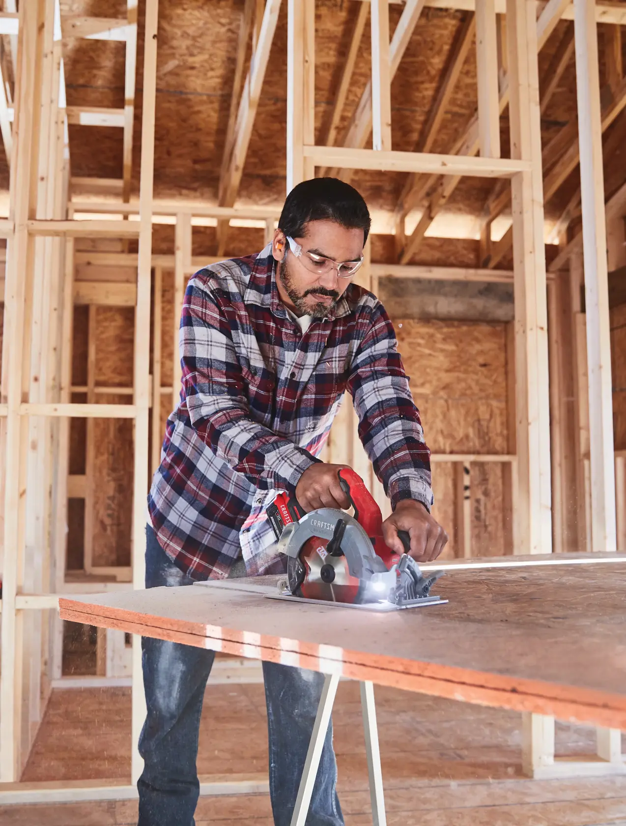 20 volt 7 1 quarter inch brushless cordless circular saw being used by a person to cut wood.