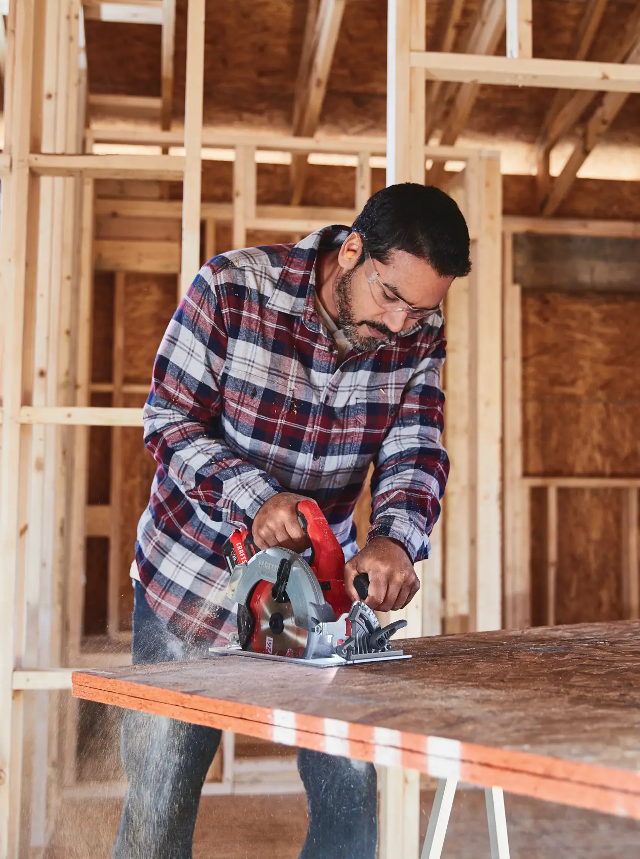 20 volt 7 1 quarter inch brushless cordless circular saw being used by a person to cut wood.