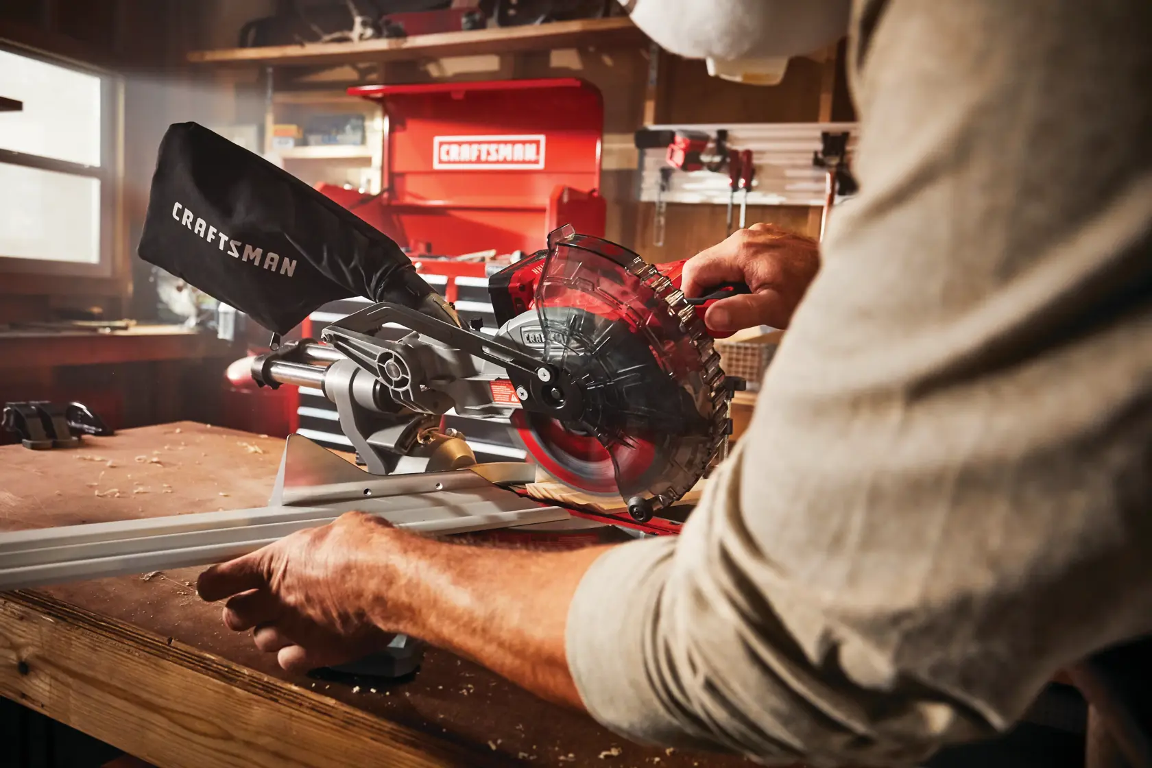 Photo of Craftsman miter saw CMCS714M1 in use, close-up view in a workshop setting.
