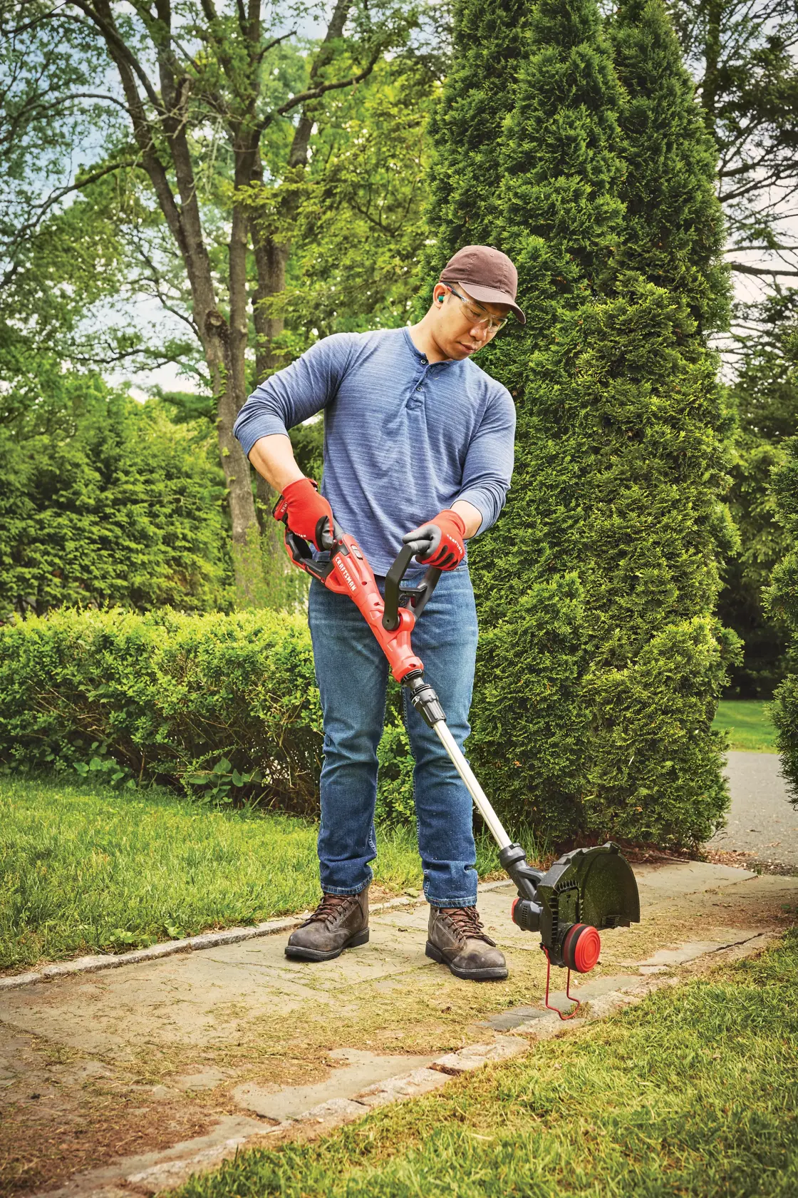 20 volt weedwacker 13 inch cordless string trimmer and edger with automatic feed kit being used by a person outdoors.