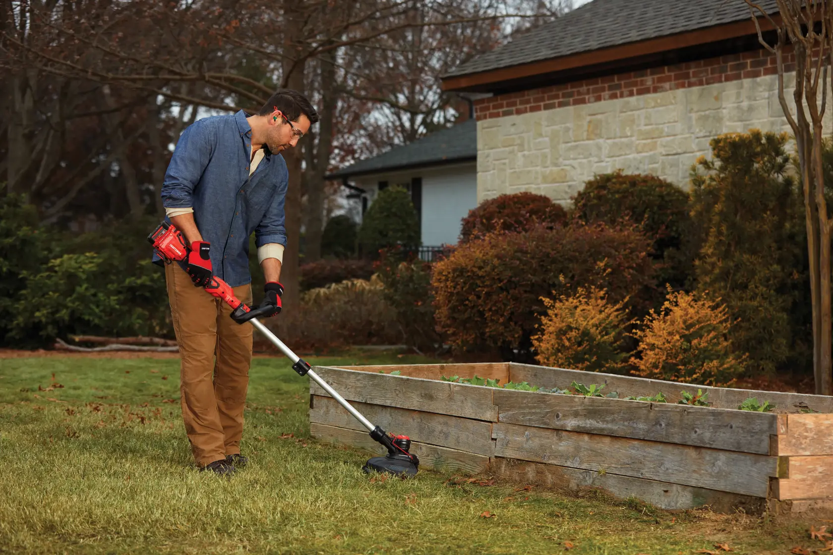 20 volt weedwacker 13 inch cordless string trimmer and edger with push button feed kit being used by a person outdoors.