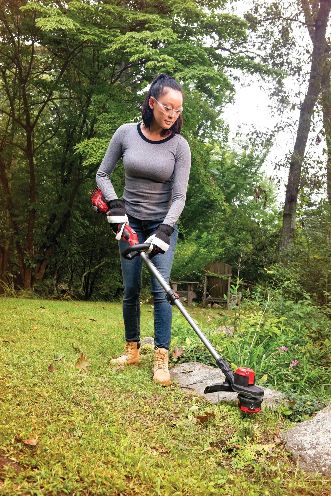 20 volt weedwacker 13 inch brushless cordless string trimmer with quickwind 4.0 ampere per hour being used by a person to trim grass outdoors.