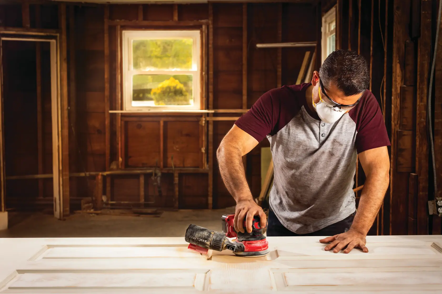 20 volt cordless random orbit sander being used by a person.
