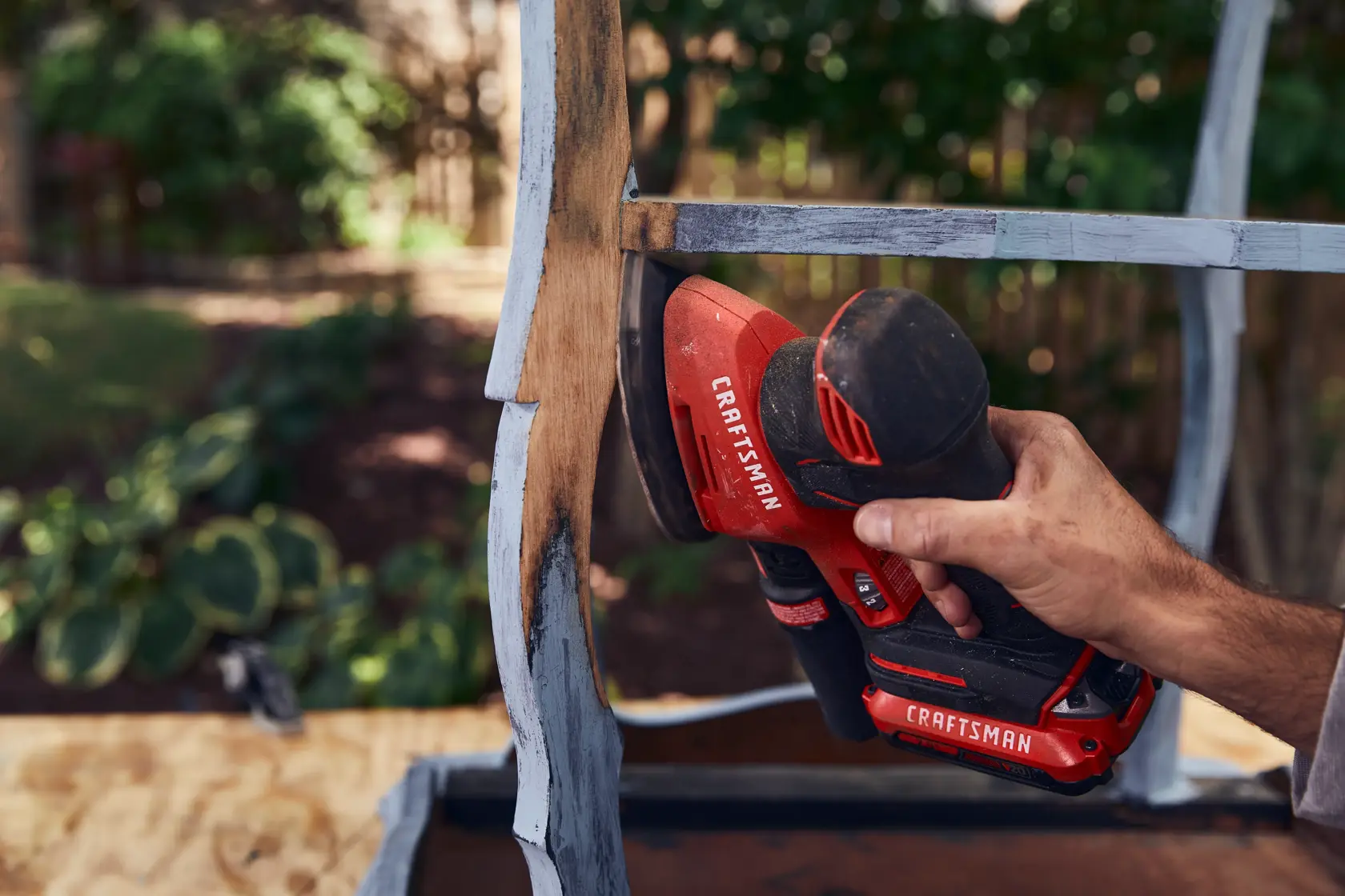 20 volt cordless detail sander being used.