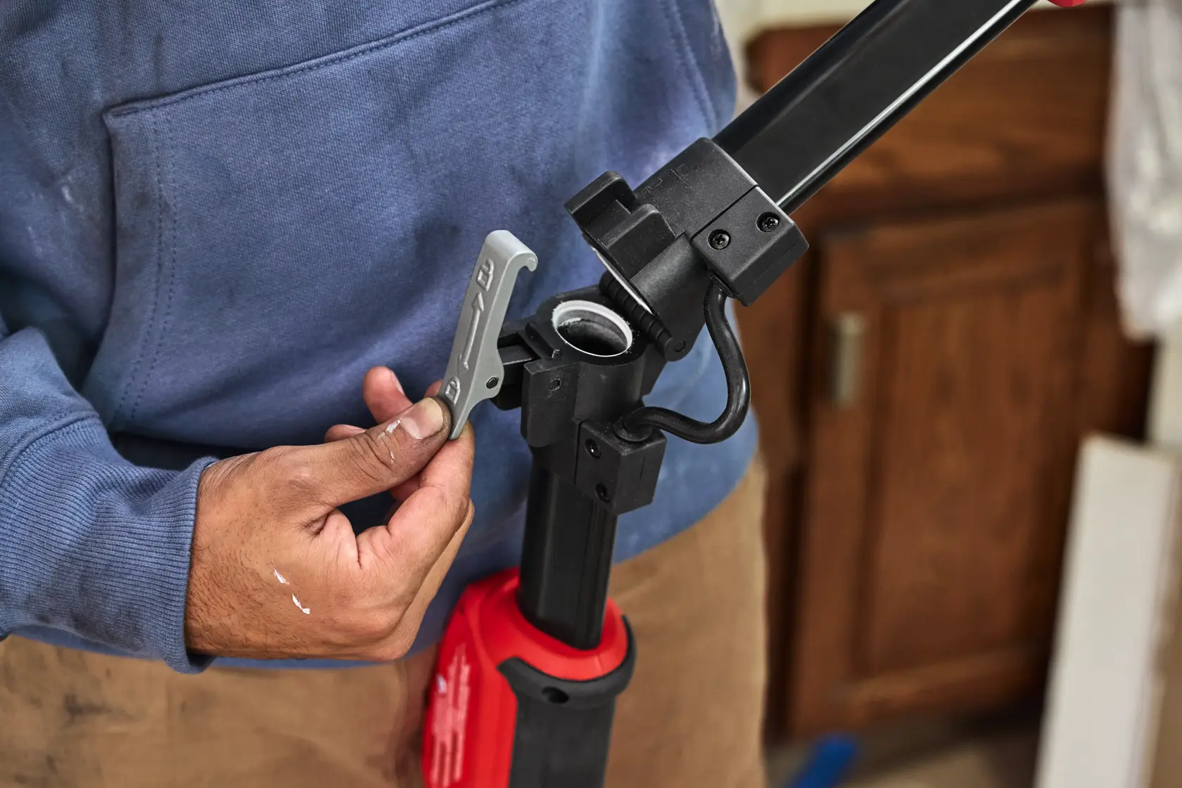 Person adjusting a CRAFTSMAN CMEW500 tool's locking mechanism in a workshop setting.
