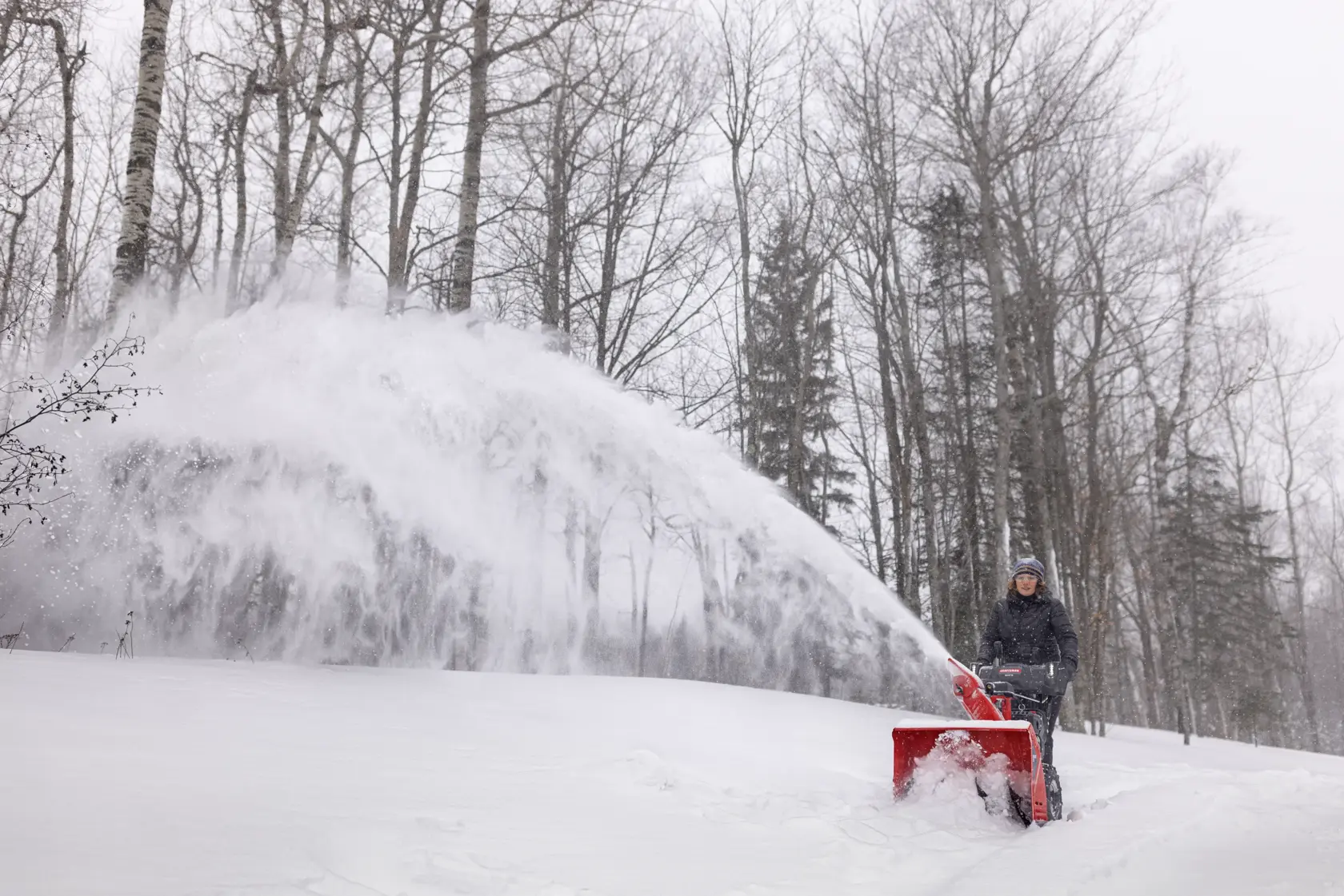 CRAFTSMAN Select 28 Snow Blower clearing snow off driveway near wooded