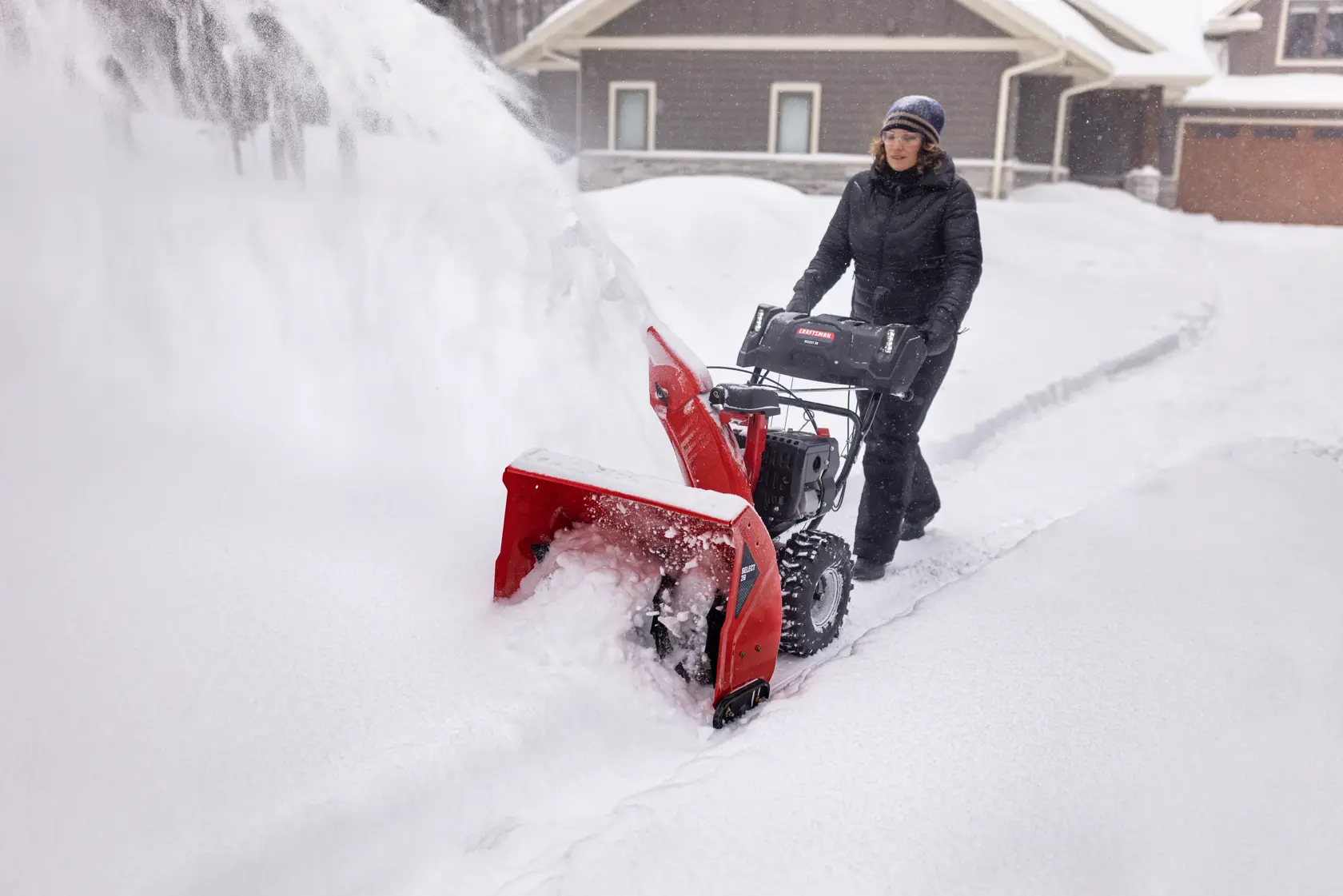 CRAFTSMAN Select 28 Snowblower clearing snow off driveway near house