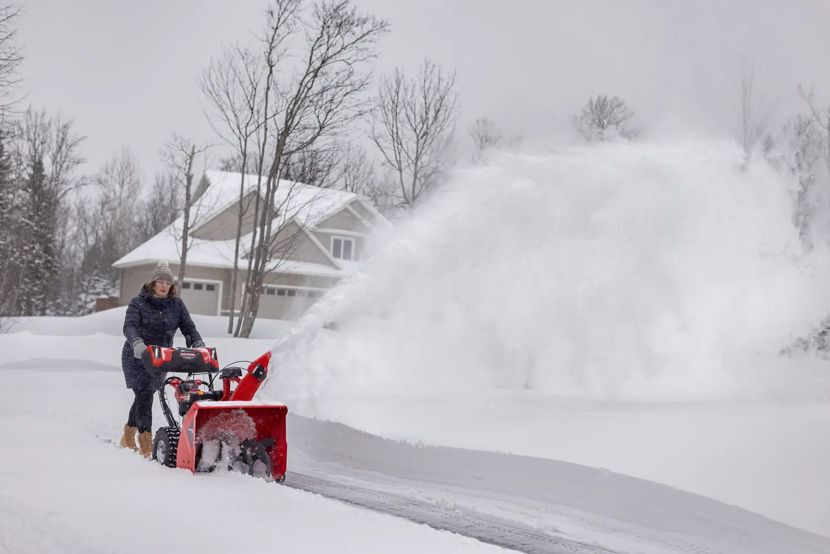 CRAFTSMAN Performance 26 V20 Start Snowblower clearing snow off driveway house in background