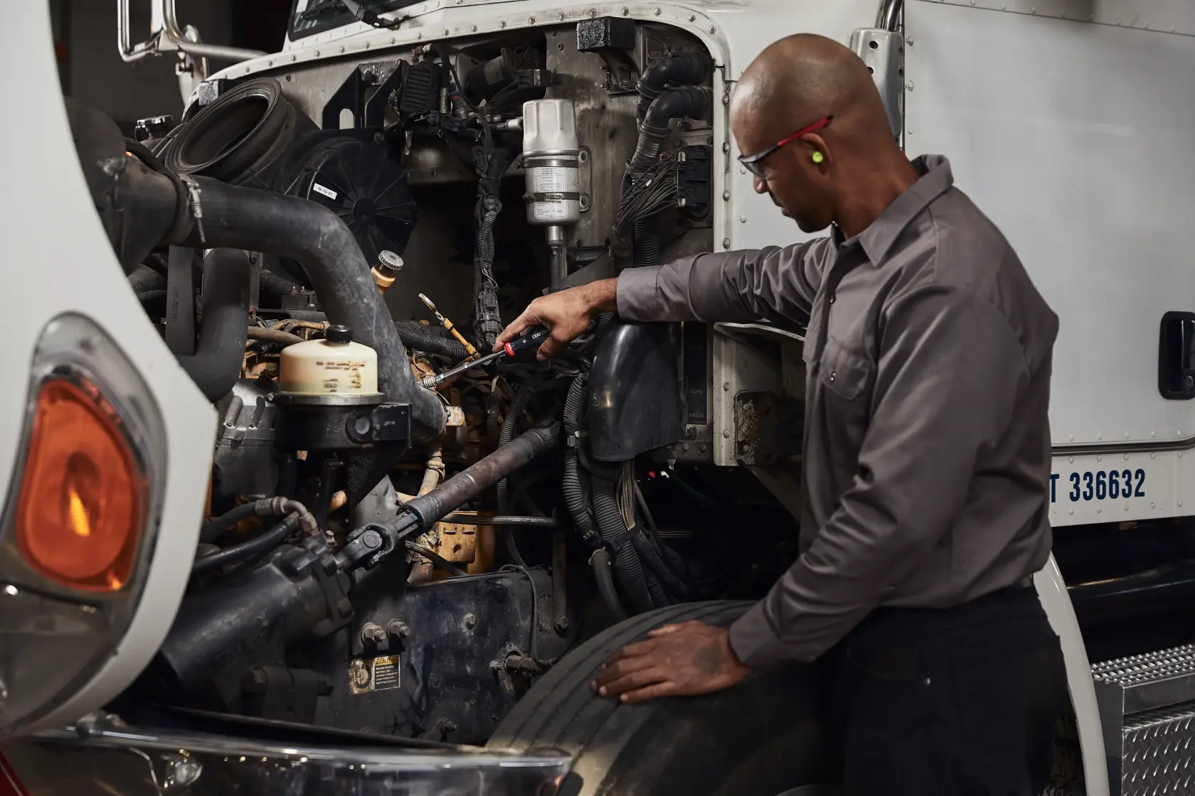 V Series 6 piece Metric Nut Driver Set being used by person on inner machinery of a vehicle.