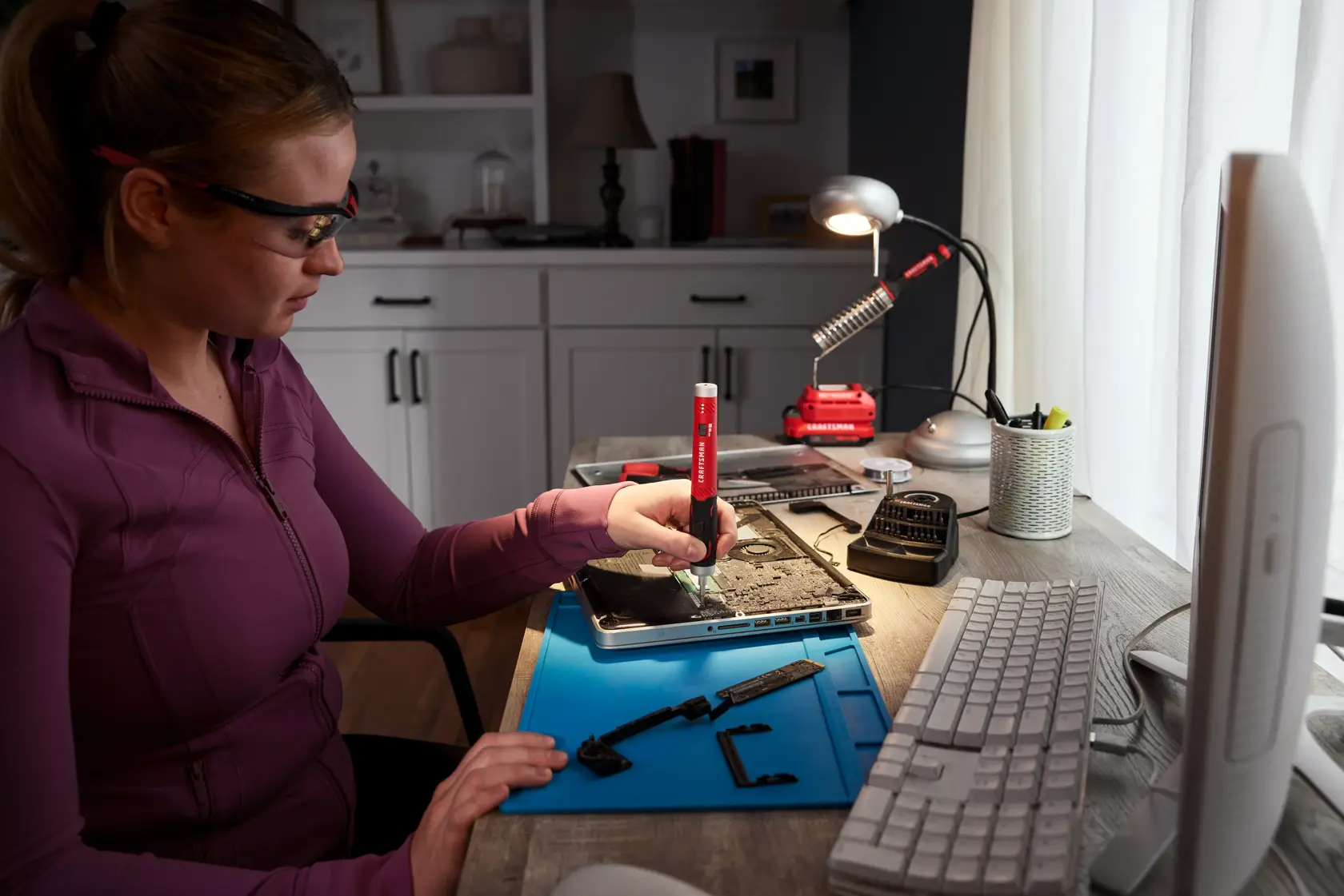 Woman fixing laptop with the CRAFTSMAN® 4V Precision Screwdriver Wide Angle