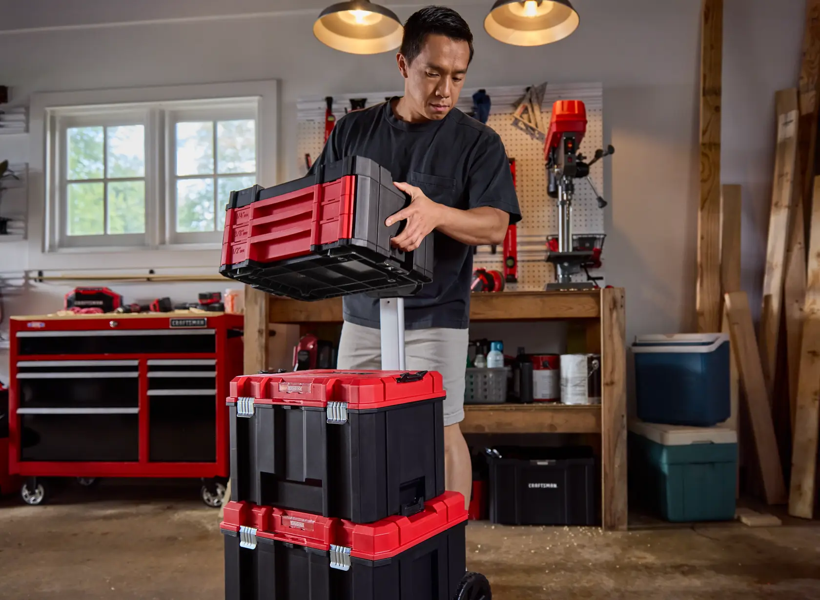 Close up garage angle man stacking CRAFTSMAN® VERSASTACK™ 242 pc. Mechanics Tool Set