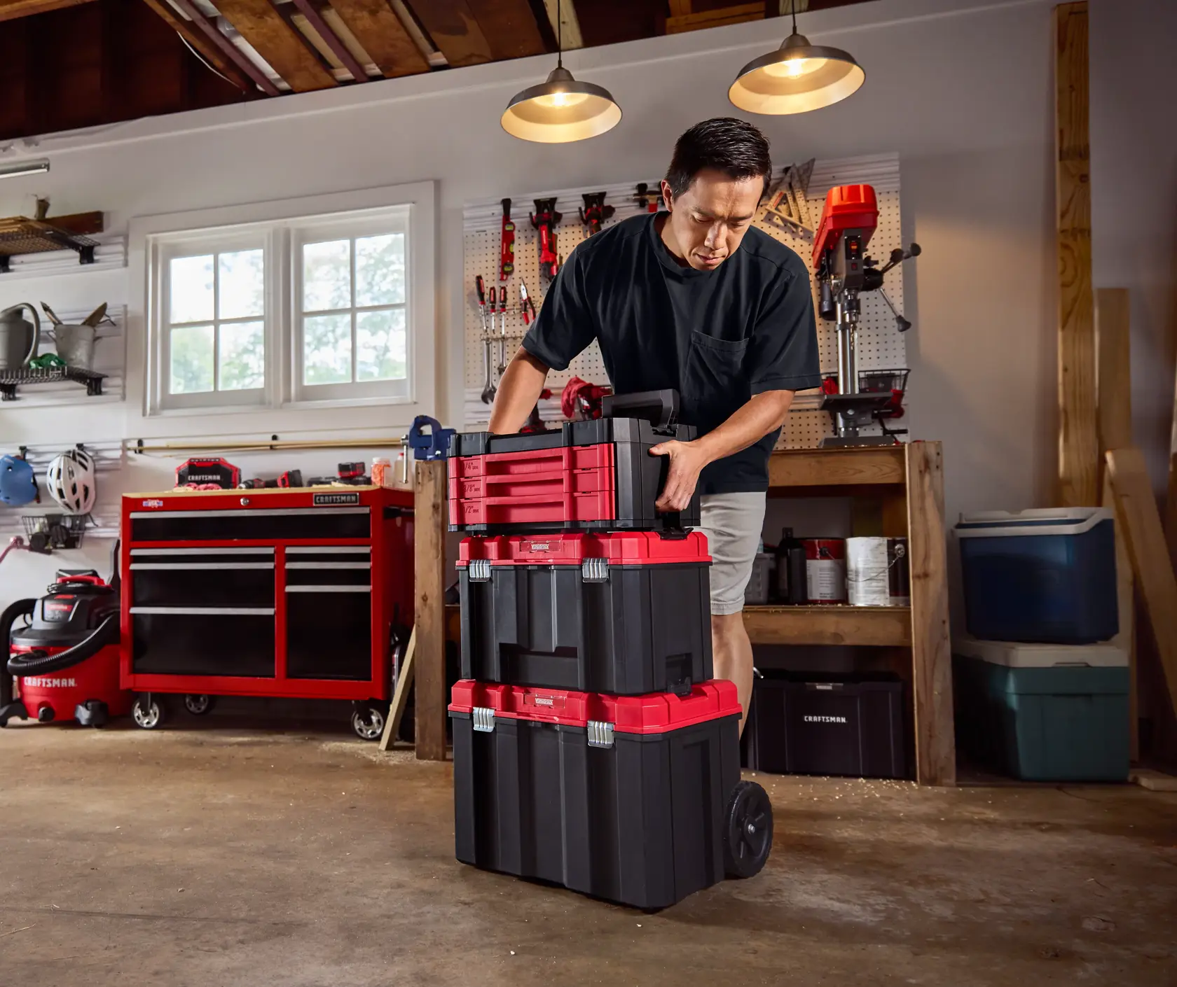 Close up garage angle man stacking CRAFTSMAN® VERSASTACK™ 242 pc. Mechanics Tool Set