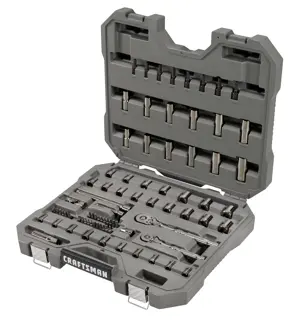 A gray plastic carrying case containing a variety of metal socket wrenches, bits, and ratchets organized in molded compartments. The case is open to show the tool set, which includes different sizes and types of sockets and attachments for mechanical and automotive work. The brand name 'Craftsman' is visible on the front of the case.