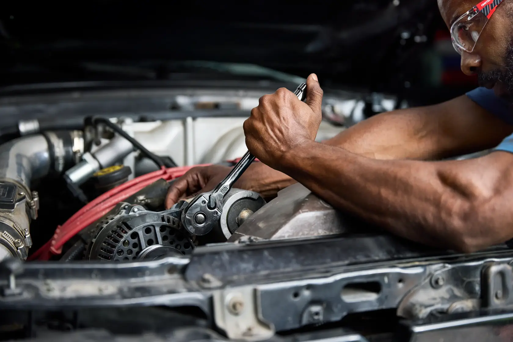 Man working on car with the CRAFTSMAN® 154PC OVERDRIVE ™ Mechanics Tool Set