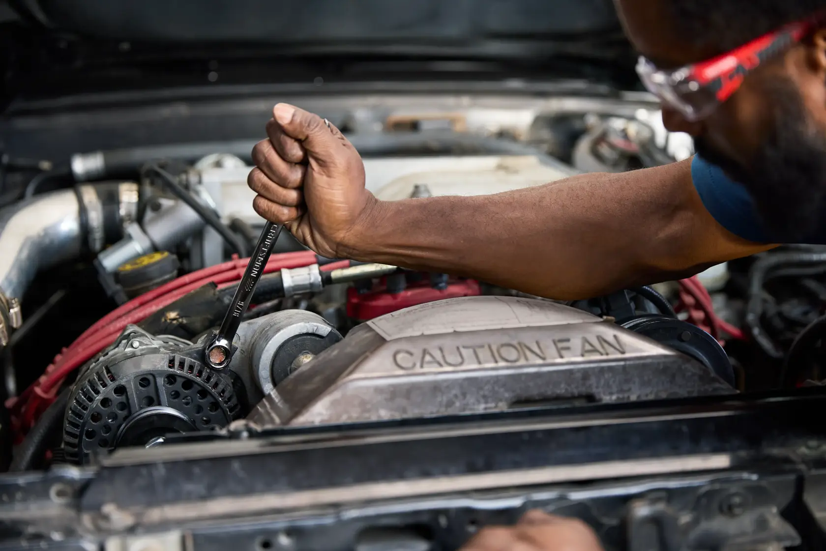 Man working on car with the CRAFTSMAN® 154PC OVERDRIVE ™ Mechanics Tool Set