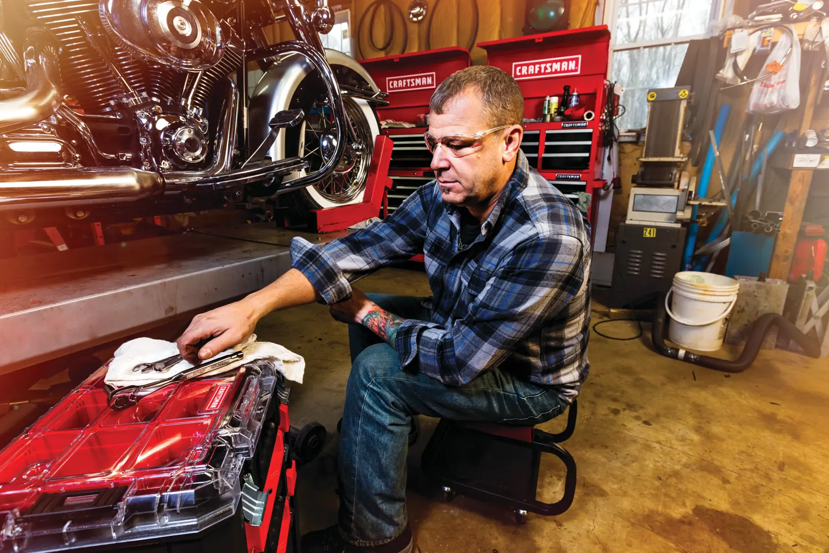 Top organizer of VersaStack System Tower being used by person to put tools while repairing a motorbike.