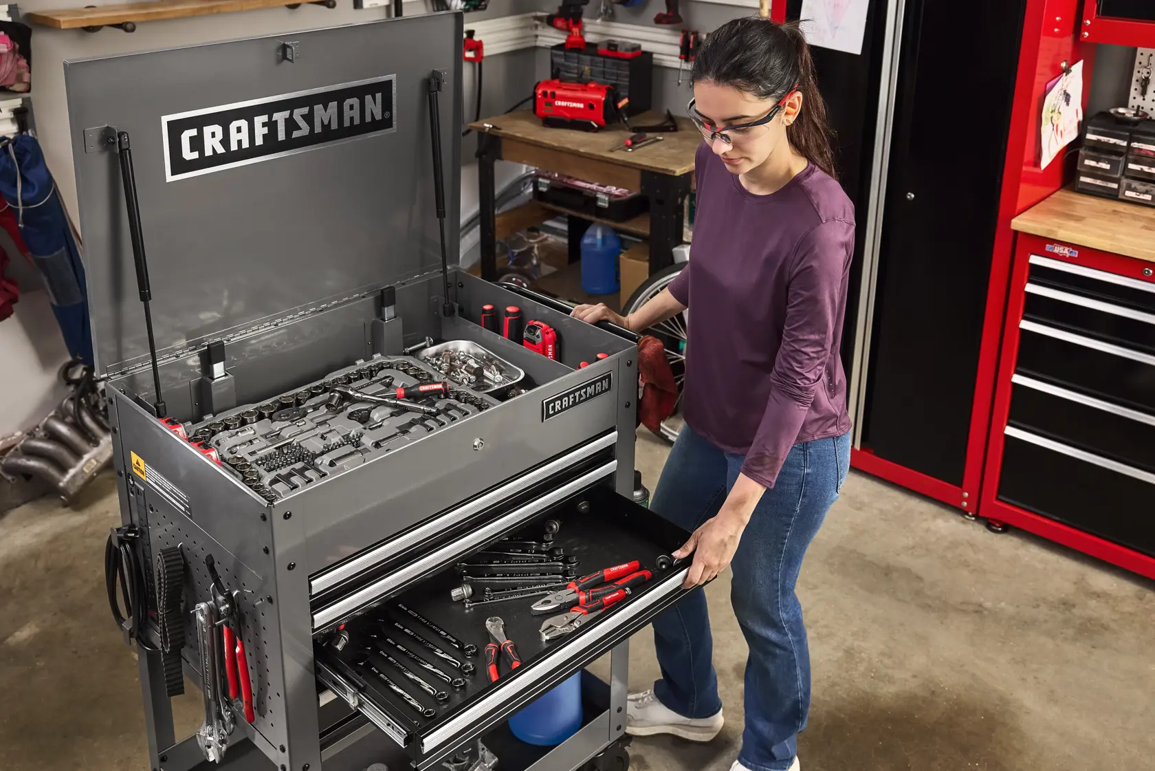 Woman pulling drawer open of CRAFTSMAN Utility Cart