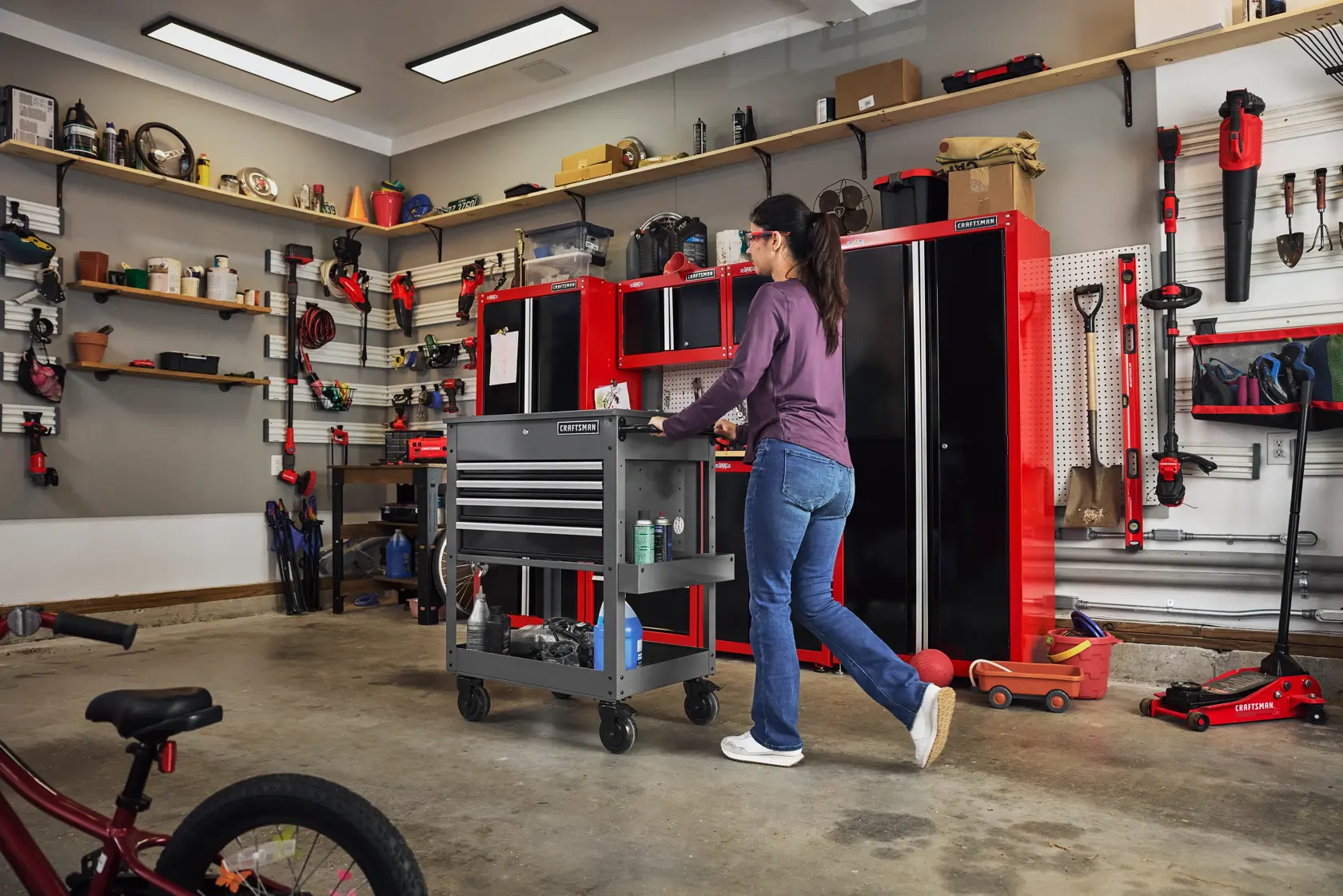 Woman pushing CRAFTSMAN Utility Cart in the garage