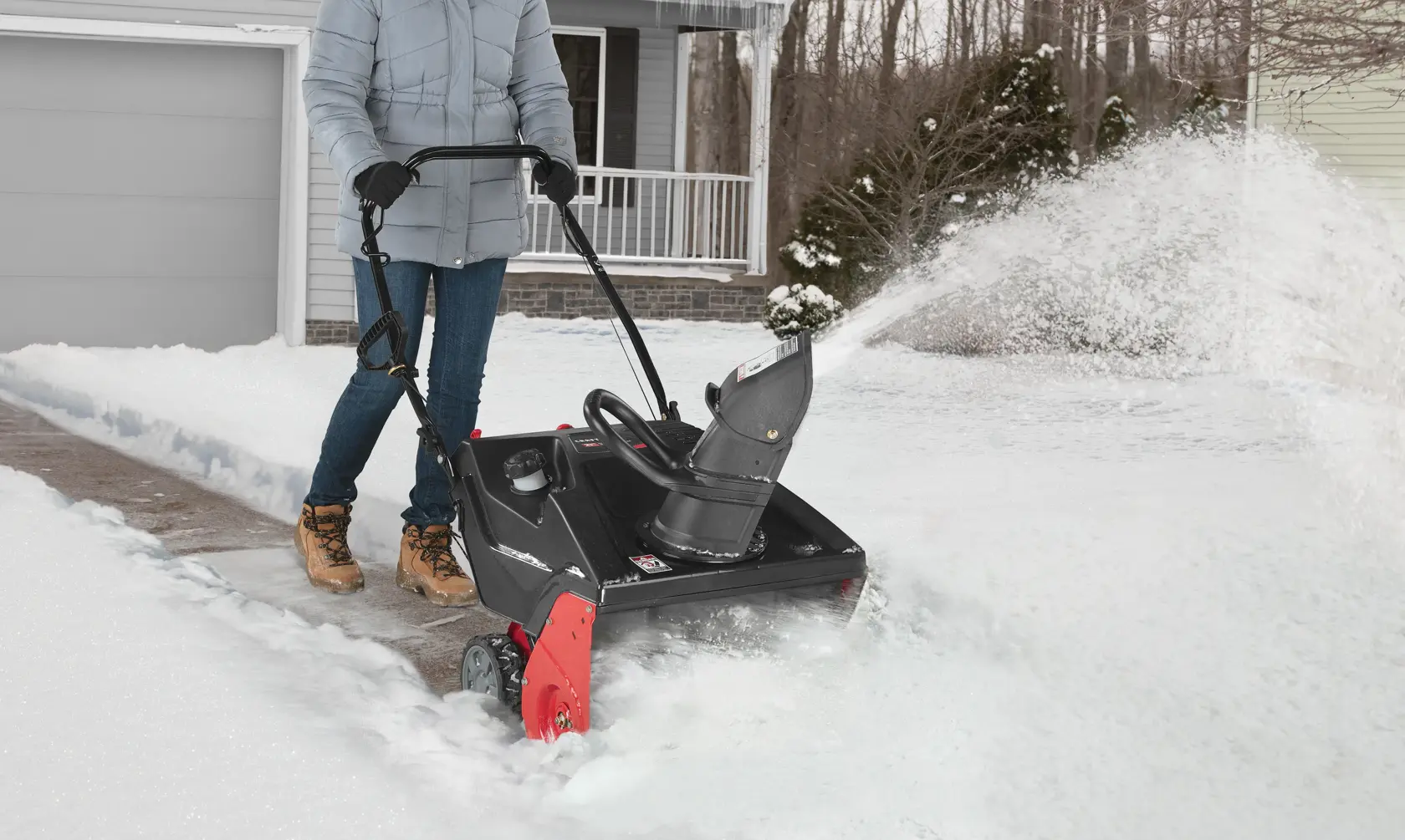 21 inch 123 CC electric start single stage snow blower being used.