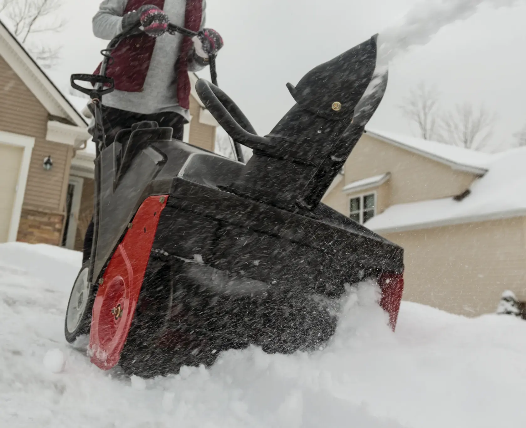 21 inch 208 CC electric start single stage snow blower being used.