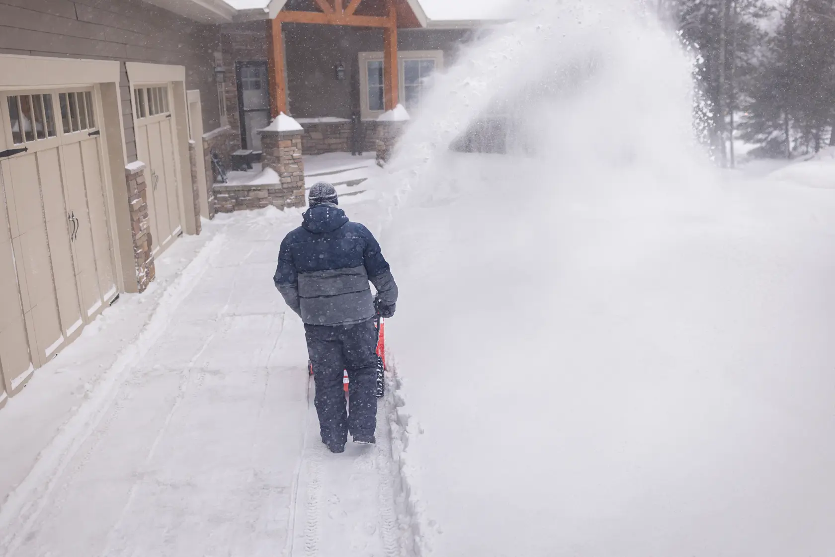 CRAFTSMAN Select 24 Snowblower clearing snow off driveway near garage