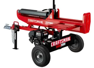 A red Craftsman log splitter machine with two wheels, a support stand, and engine visible, designed for splitting logs. The branding and '27 TON' are clearly marked on the frame.