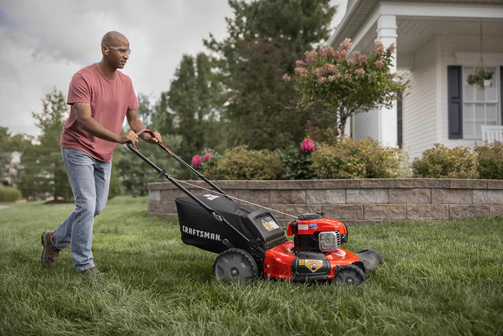 CRAFTSMAN 21-in 150cc Gas Push Mower mowing yard in front of house