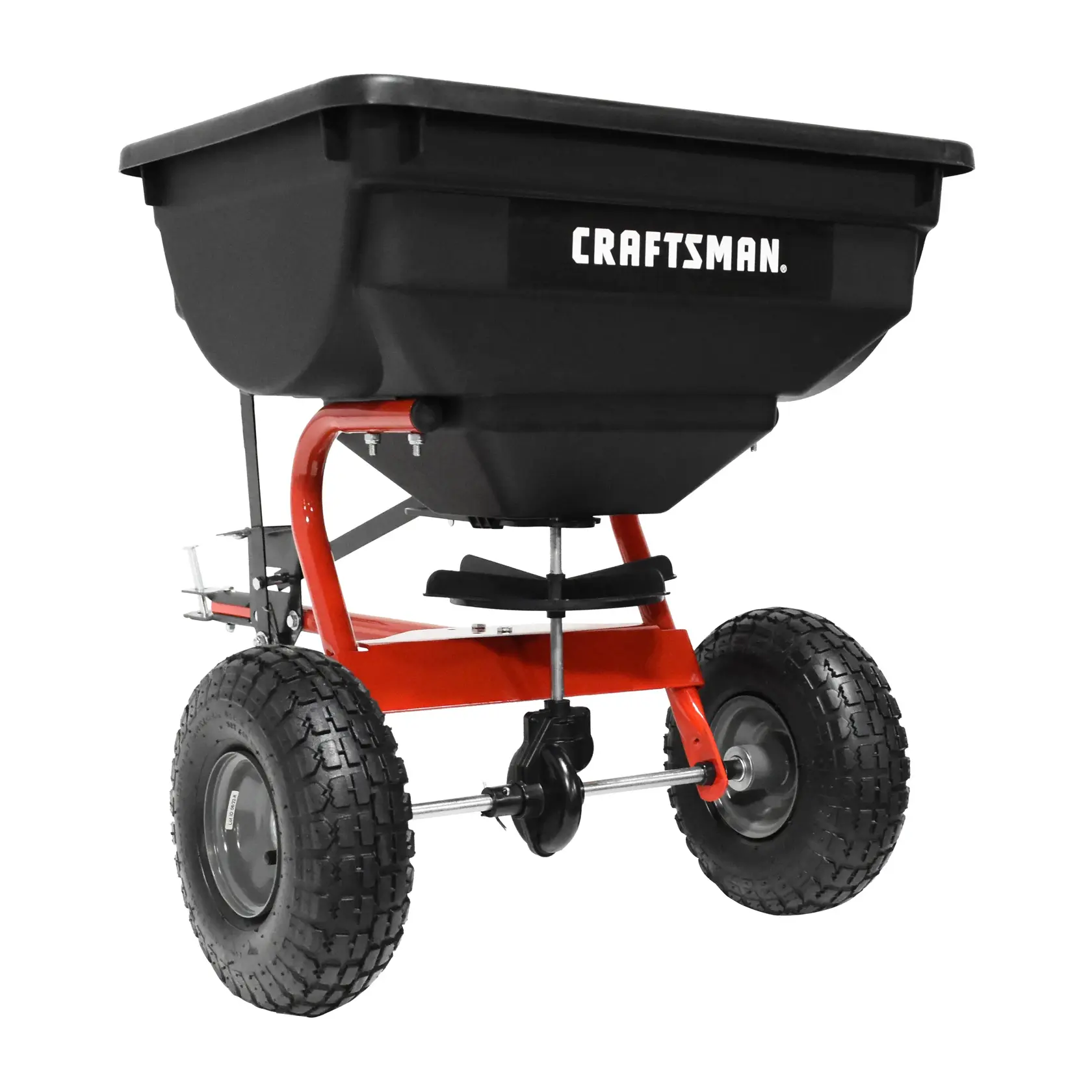 A black and red wheeled spreader with a large plastic hopper, designed for distributing materials such as seeds or fertilizer. The word 'CRAFTSMAN' is visible on the hopper.