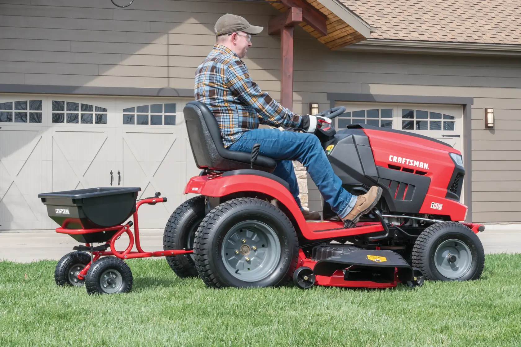 85 pounds tow broadcast spreader being used to spread fertilizer in lawn by person.