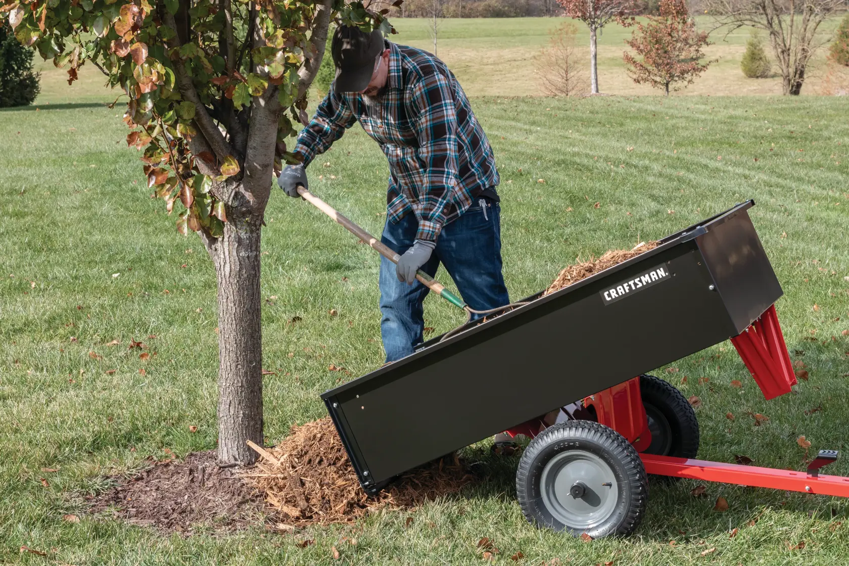 12 cubic foot steel dump cart being unloaded by person.