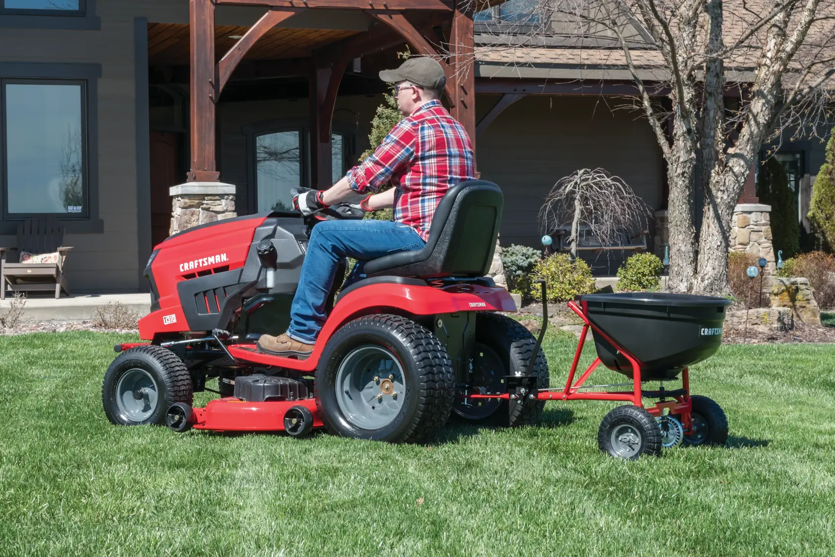 110 pounds tow broadcast spreader being used in the lawn.