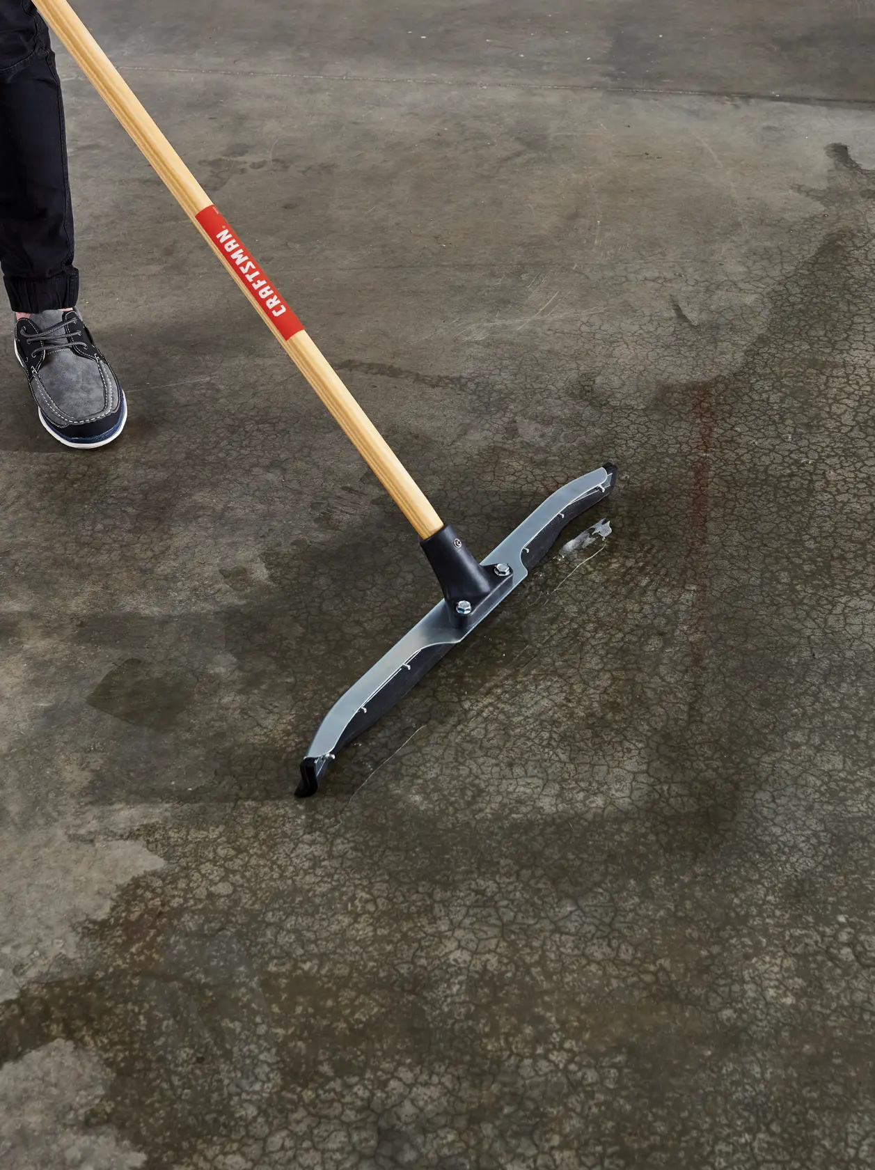 24 inch dual-blade floor squeegee cleaning water on garage floor