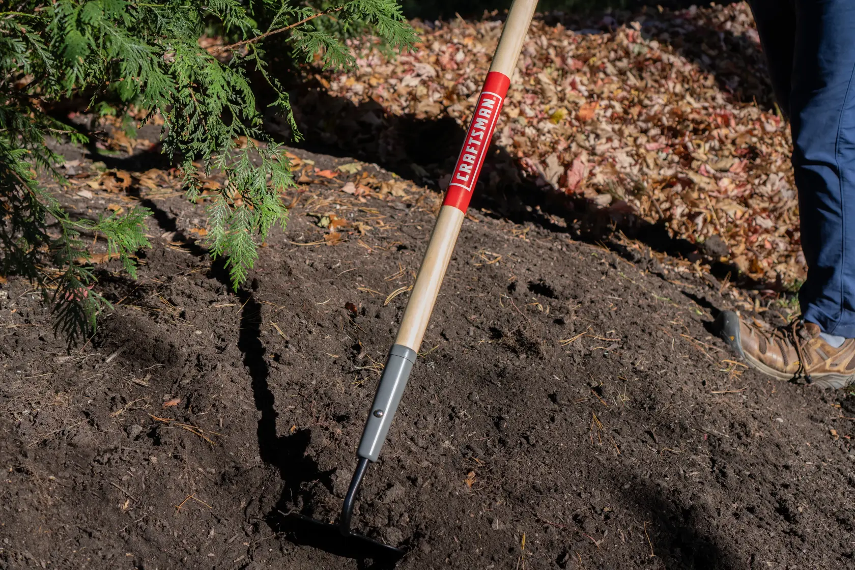 Long Handle Forged Steel Chopping and Weeding Garden Hoe with wood handle and cushion grip, in action 