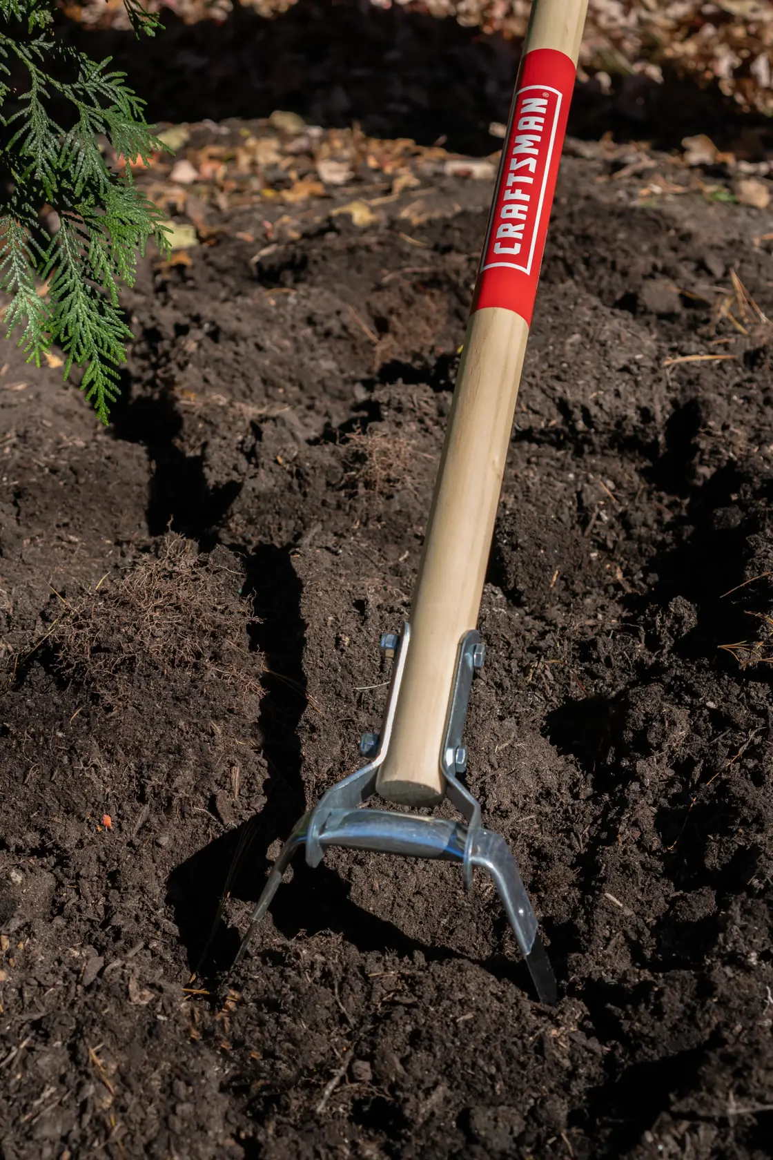 Long Handle Stirrup Shaped Steel Weed Cutting Scuffle Hoe with wood handle and cushion grip, in action 