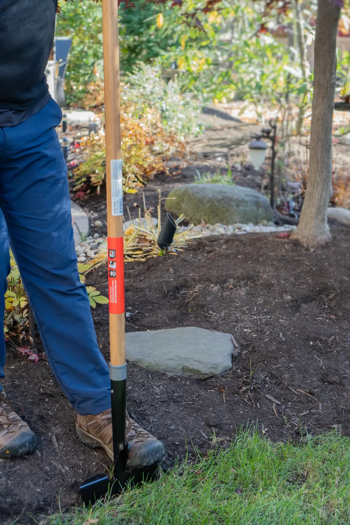 Long Handle Half Moon Shaped Steel Landscape Bed Edger with wood handle and cushion grip, in action 