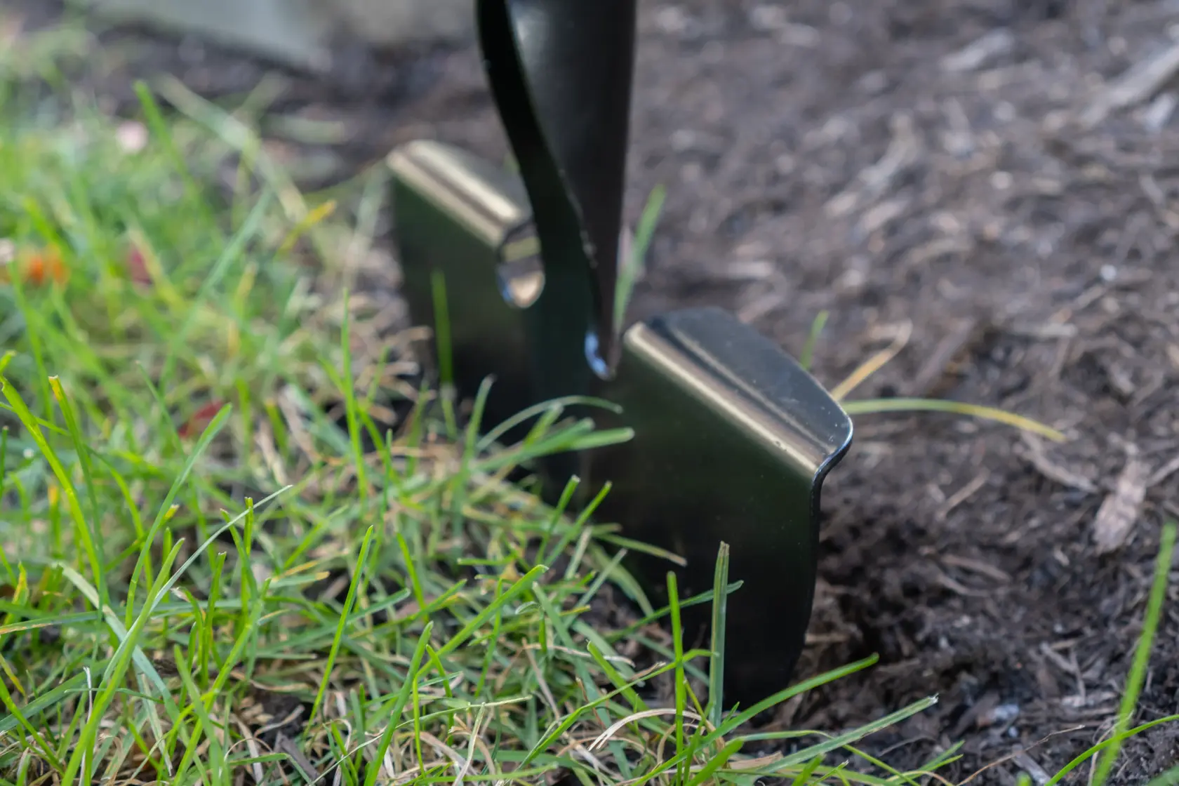 Long Handle Half Moon Shaped Steel Landscape Bed Edger with wood handle and cushion grip, in action 