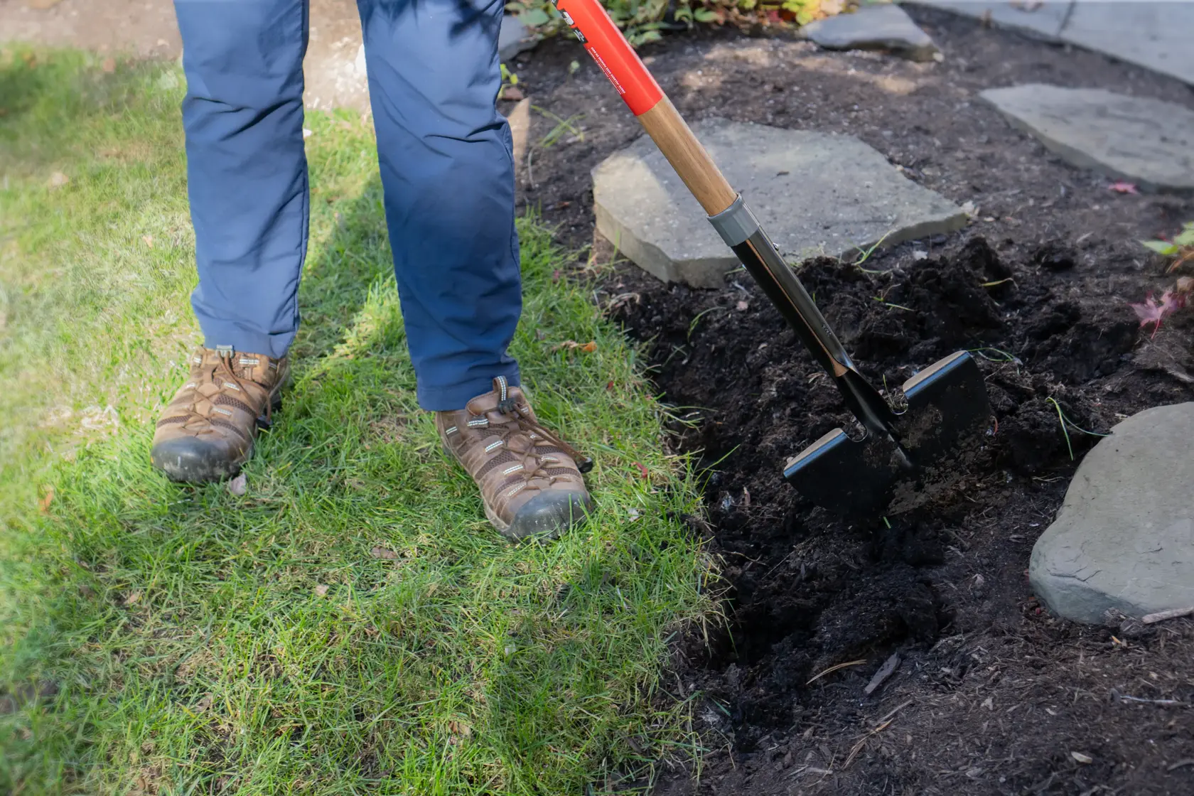 Long Handle Half Moon Shaped Steel Landscape Bed Edger with wood handle and cushion grip, in action 