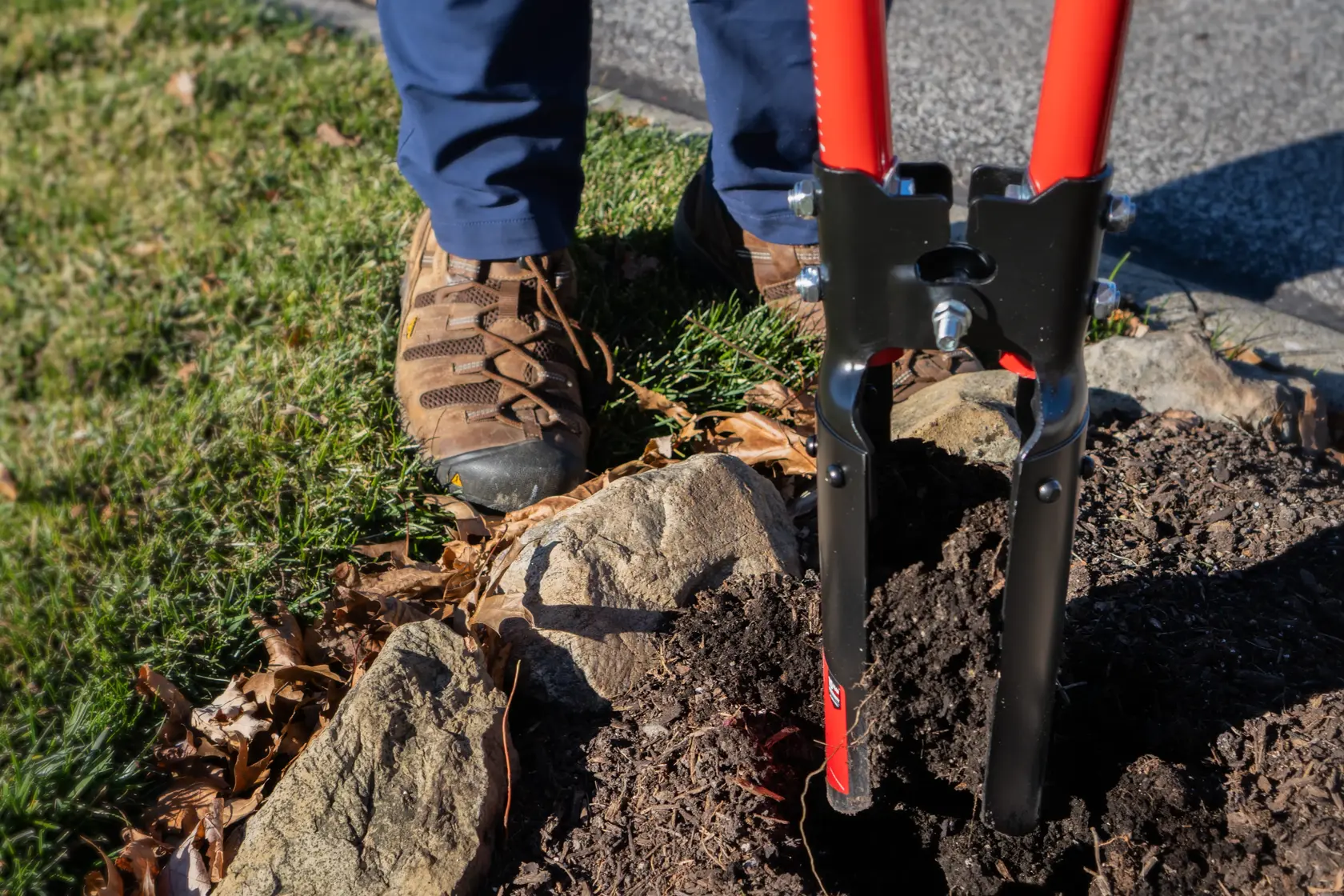 Two Handle Post Hold Digger with fiberglass handles and cushioin grips, in action digging