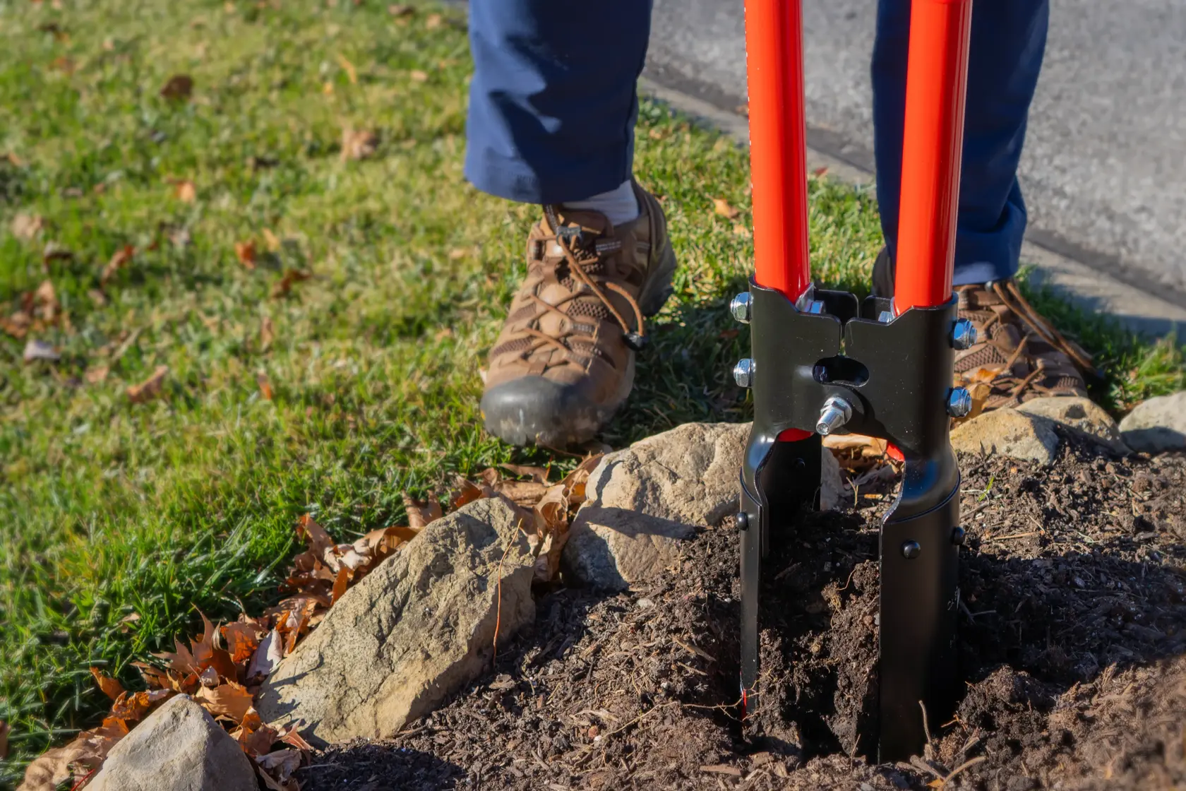 Two Handle Post Hold Digger with fiberglass handles and cushioin grips, in action digging