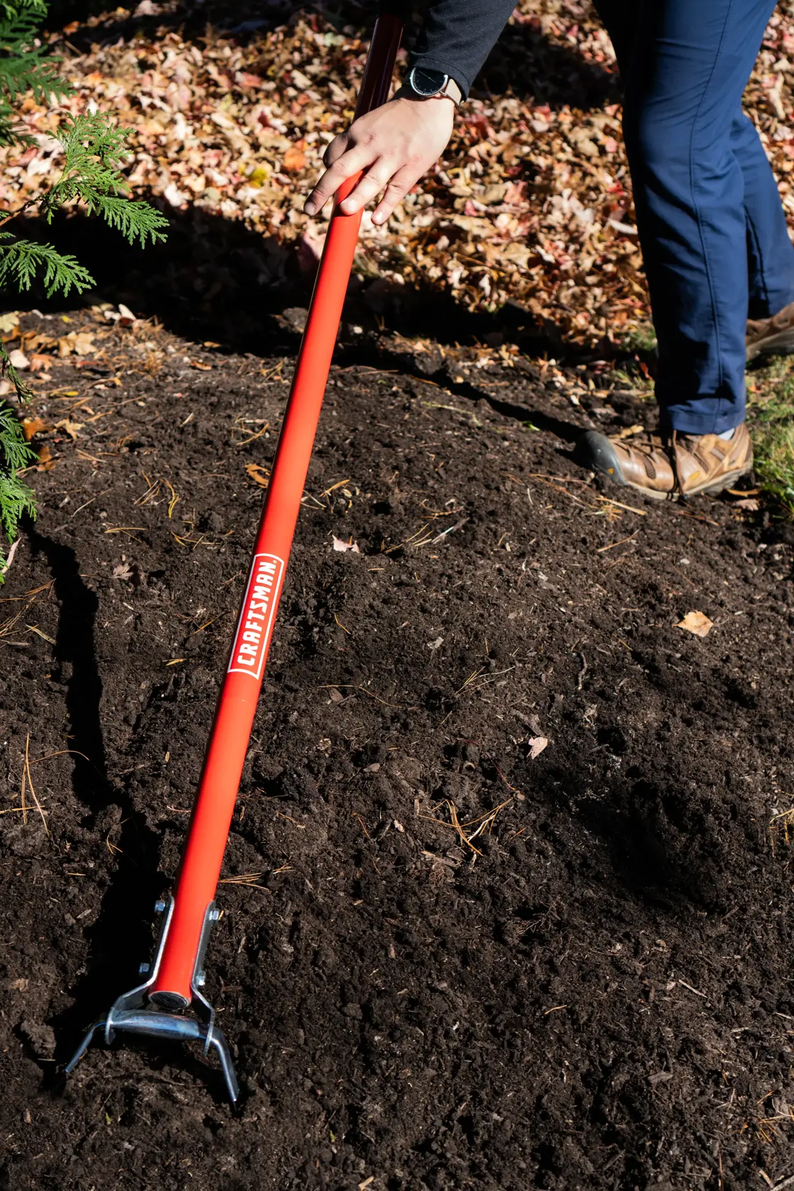 Long Handle Stirrup Shaped Steel Weed Cutting Scuffle Hoe with fiberglass handle and cushion grip, in action shot