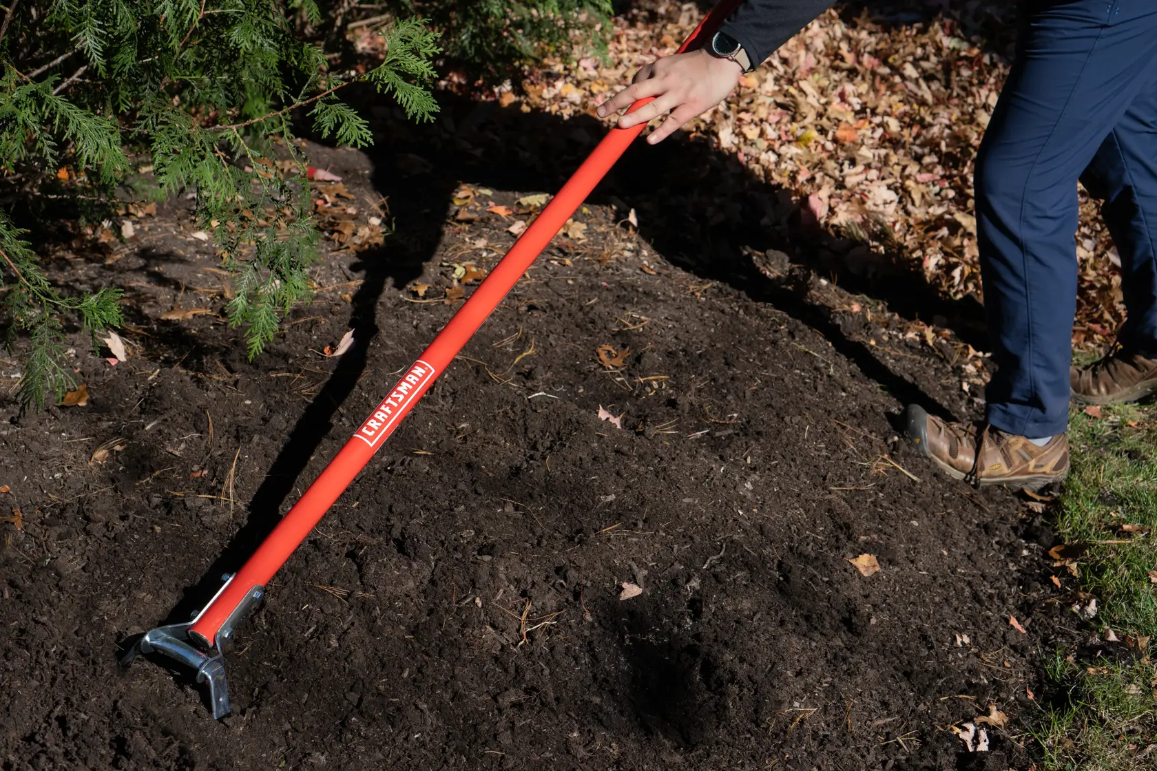 Long Handle Stirrup Shaped Steel Weed Cutting Scuffle Hoe with fiberglass handle and cushion grip, in action shot