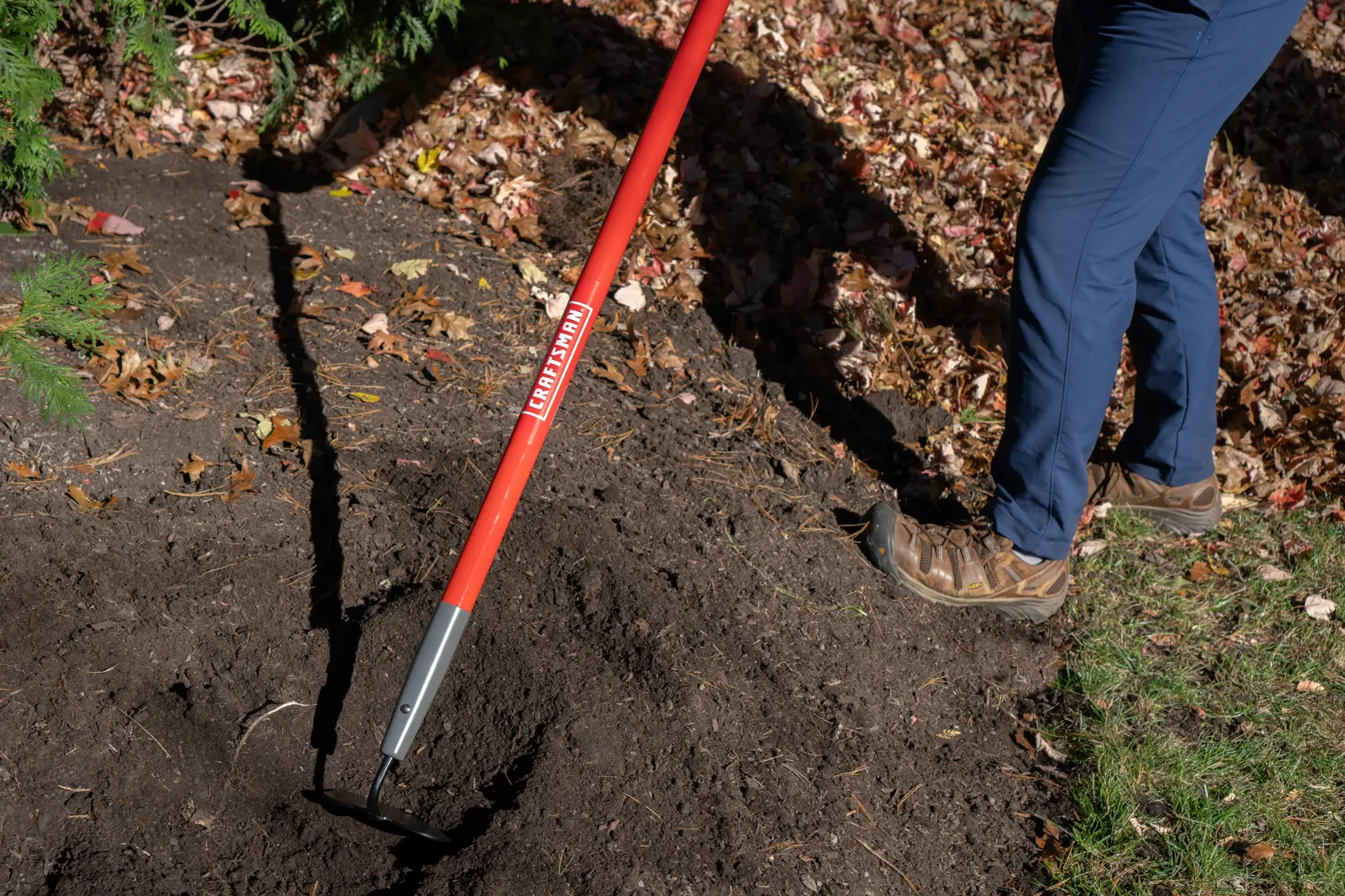 Long Handle Forged Steel Chopping and Weeding Garden Hoe with fiberglass handle and cushion grip, in action 