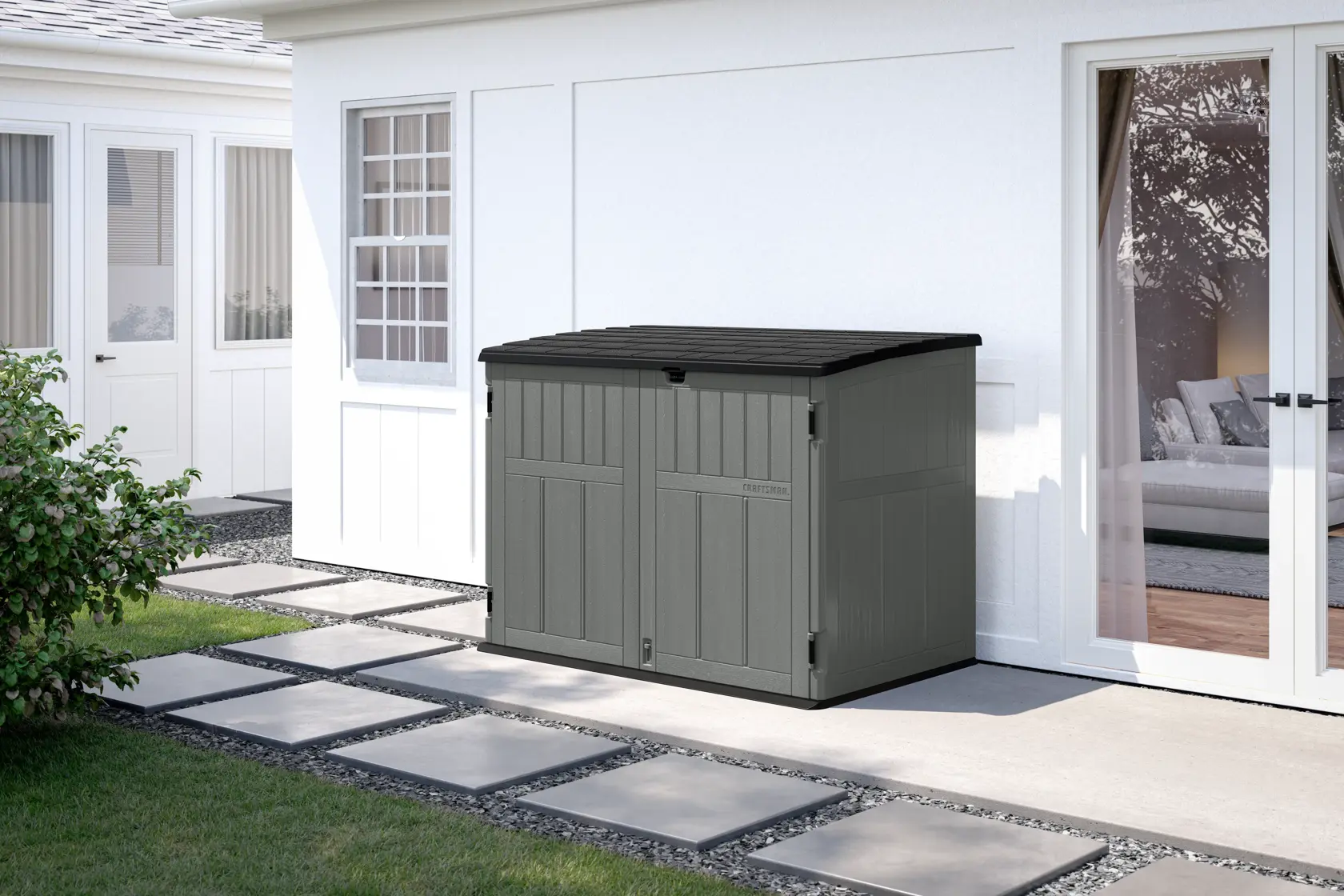 Photo of CRAFTSMAN outdoor storage shed, SKU CMXRCSCBMSC4752Z, gray double-door unit placed beside a house on patio.