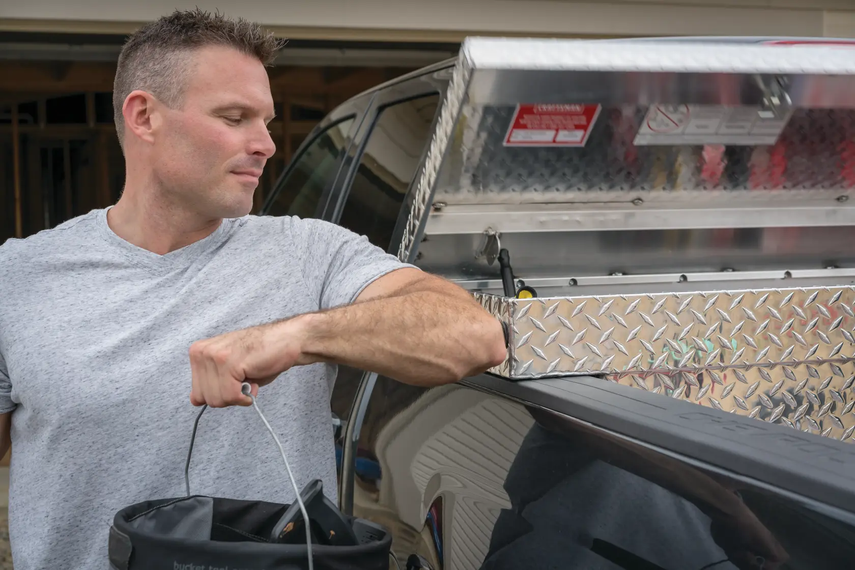 Photo of CRAFTSMAN truck toolbox SKU CMXTBAK1000901 in open position, diamond plate finish, mounted on pickup.