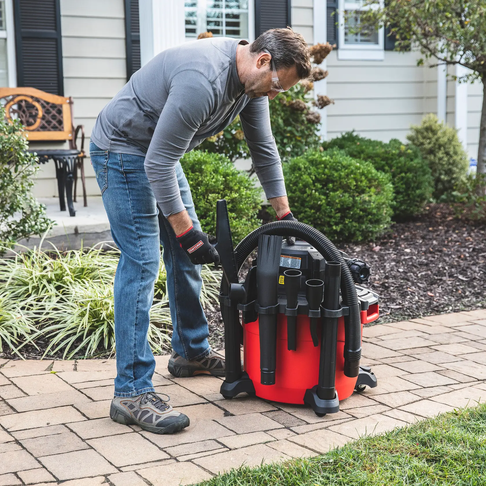 Person storing accessories on  CRAFTSMAN vac that has a 2-1/2 inch Muffler Diffuser installed 