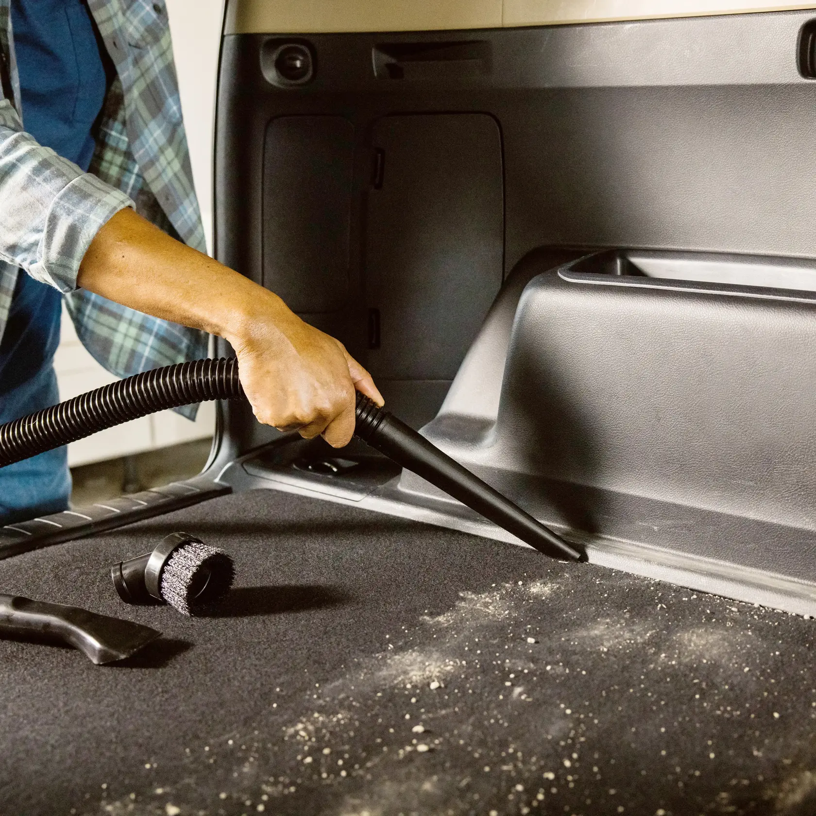 Photo of Craftsman vacuum cleaning car interior, SKU CMXZVBE38662, showing hose and attachments in use.