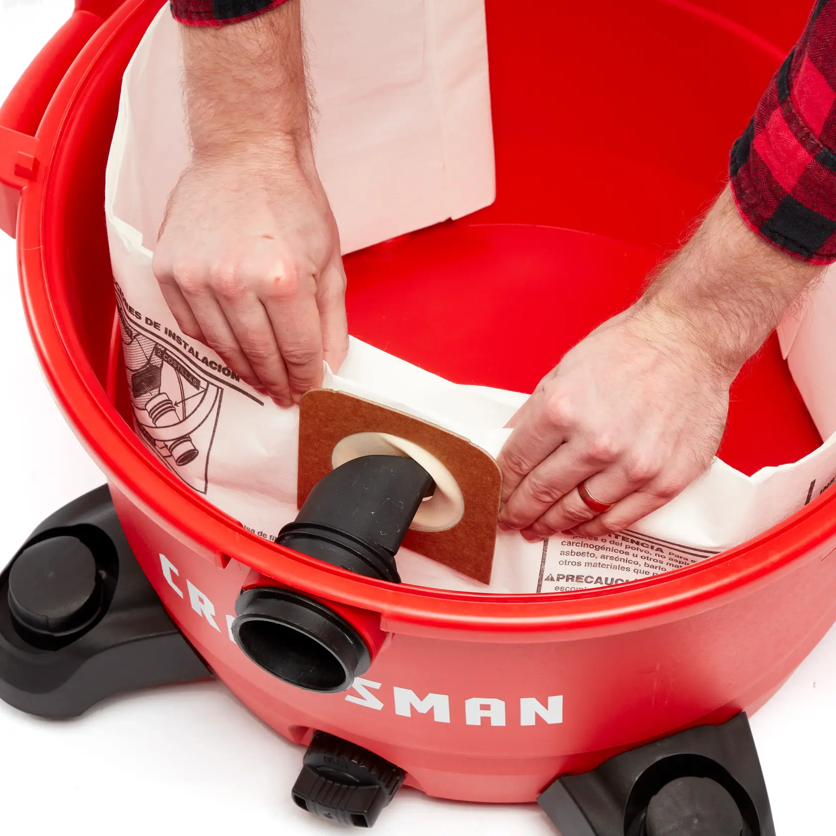 Top view of CRAFTSMAN 12 gallon dust collection bag installation on inlet inside vac drum